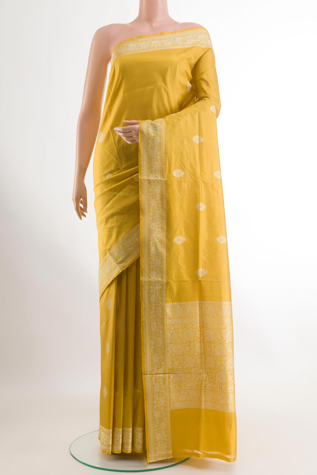 Yellow Banarasi Katan Silk Saree with Zari Butta on the body and Zari Border.  displayed on a mannequin