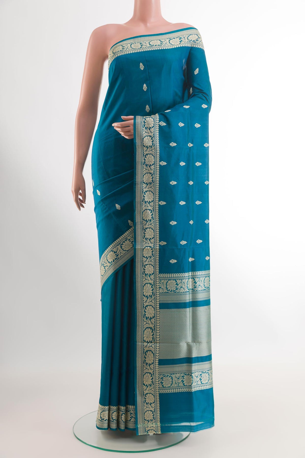 Blue Banarasi Katan Silk Saree with Zari Butta on the body and Zari Border.  displayed on a mannequin