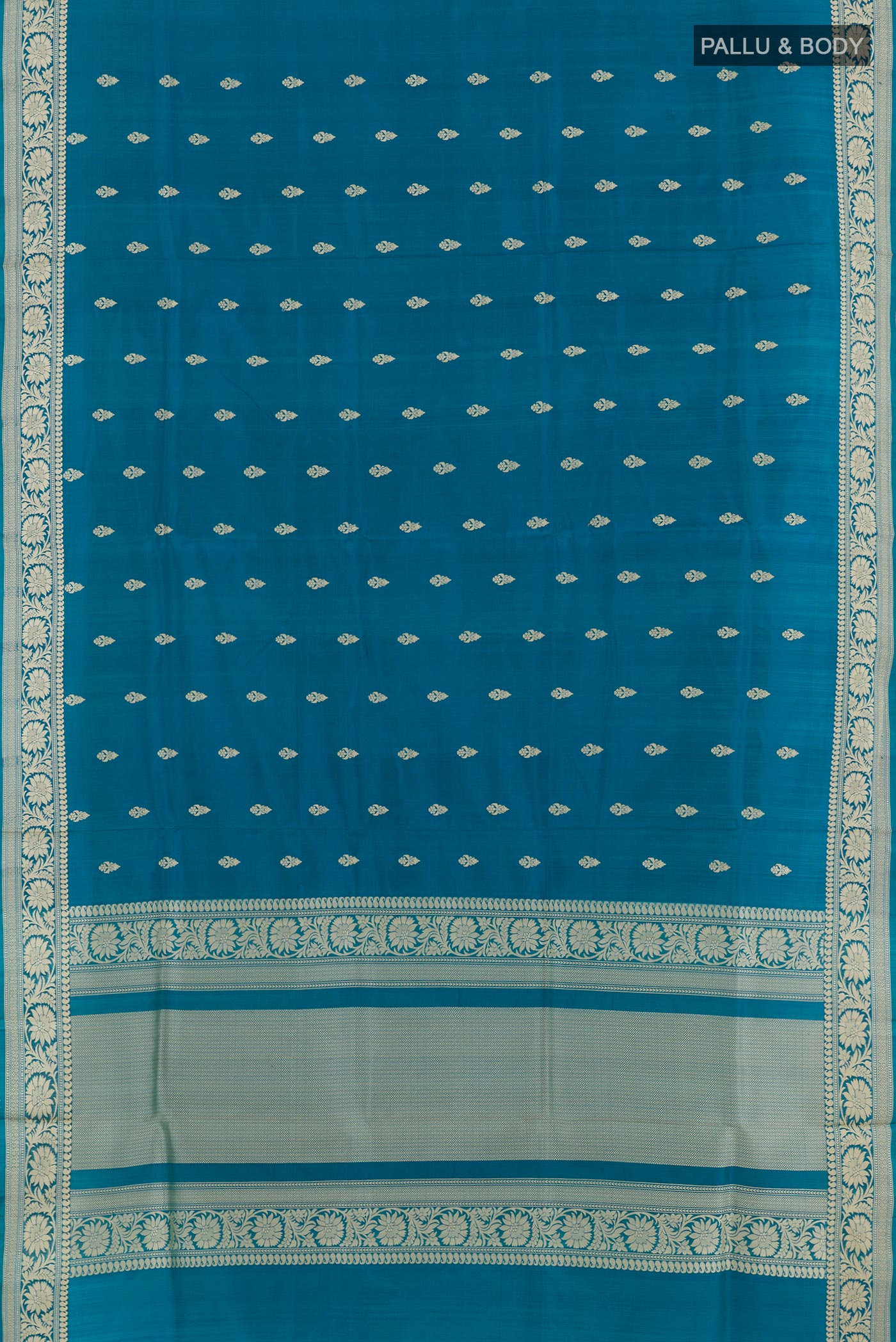 Flat view of Blue Banarasi Katan Silk Saree with Zari Butta on the body and Zari Border. 