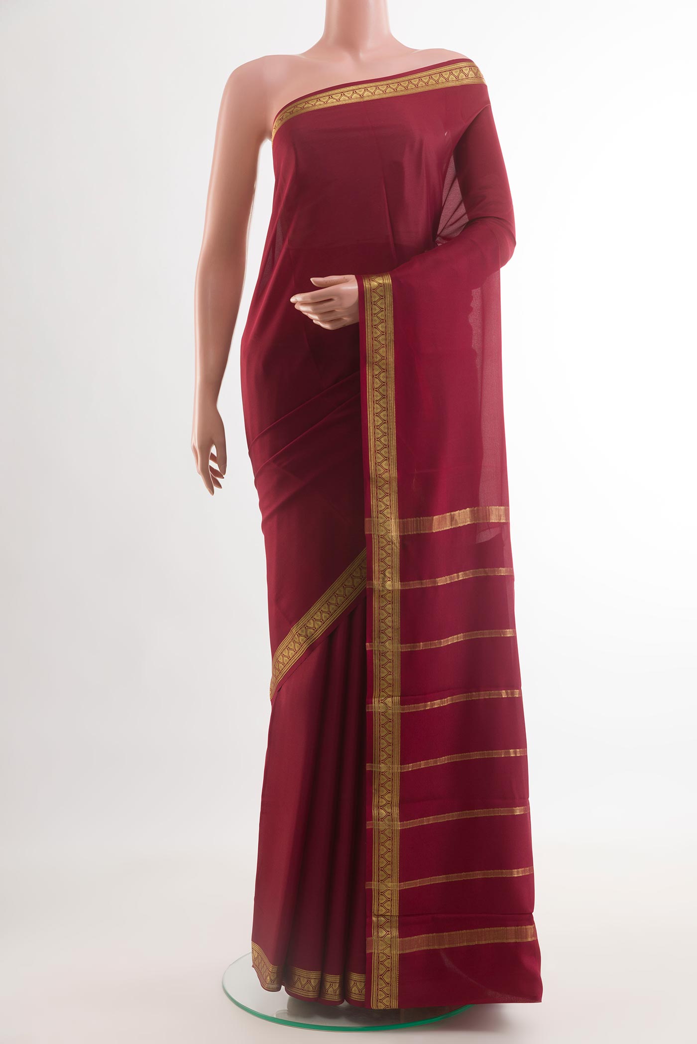 Maroon Mysore Crepe Saree with Plain Body and Zari Border.  displayed on a mannequin