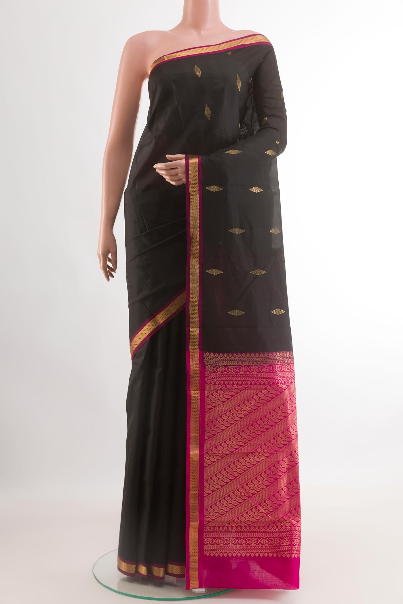 Black Kanchipuram Silk Saree with Zari Butta on the body and Zari Border.  displayed on a mannequin