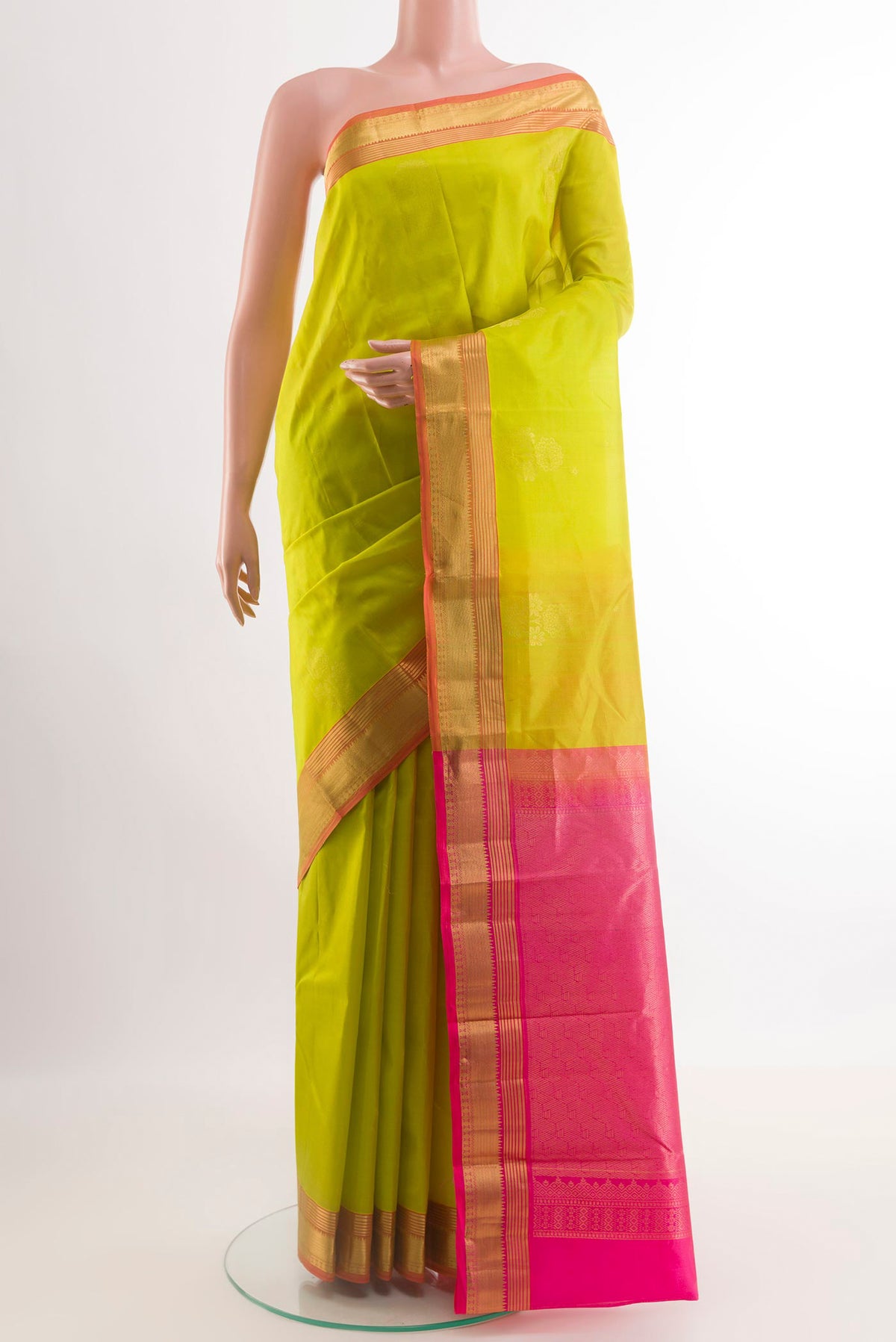 Light Green Kanjivaram Silk Saree with Zari Butta on the body and Zari Border.  displayed on a mannequin