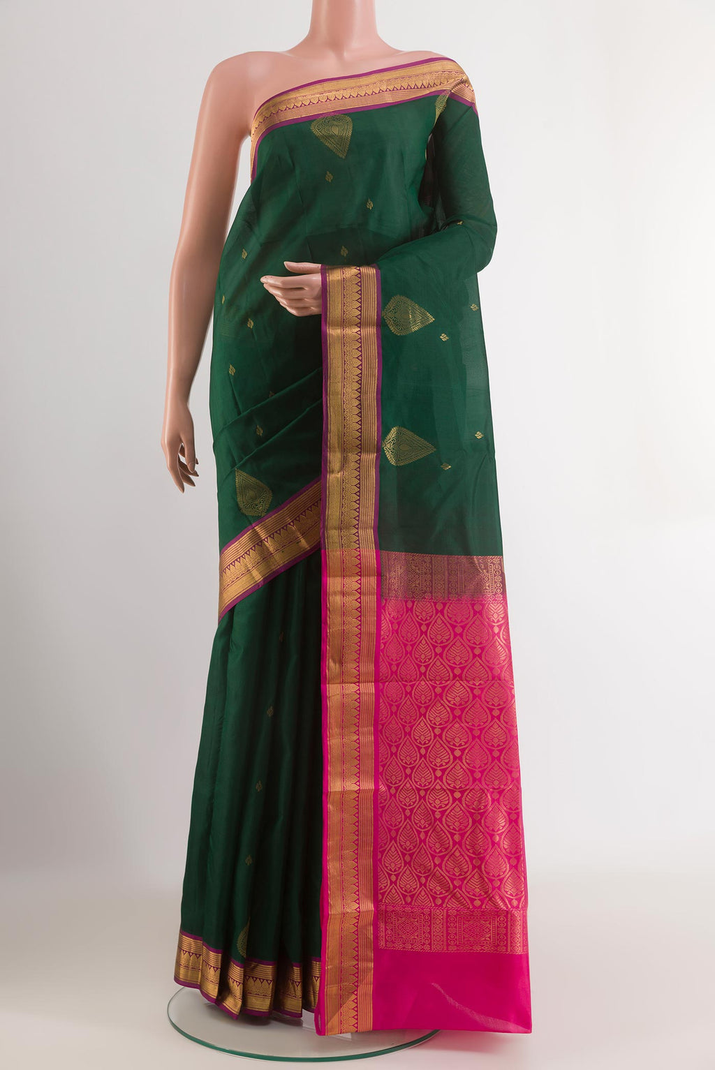 Green Kanjivaram Silk Saree with Zari Butta on the body and Zari Border.  displayed on a mannequin