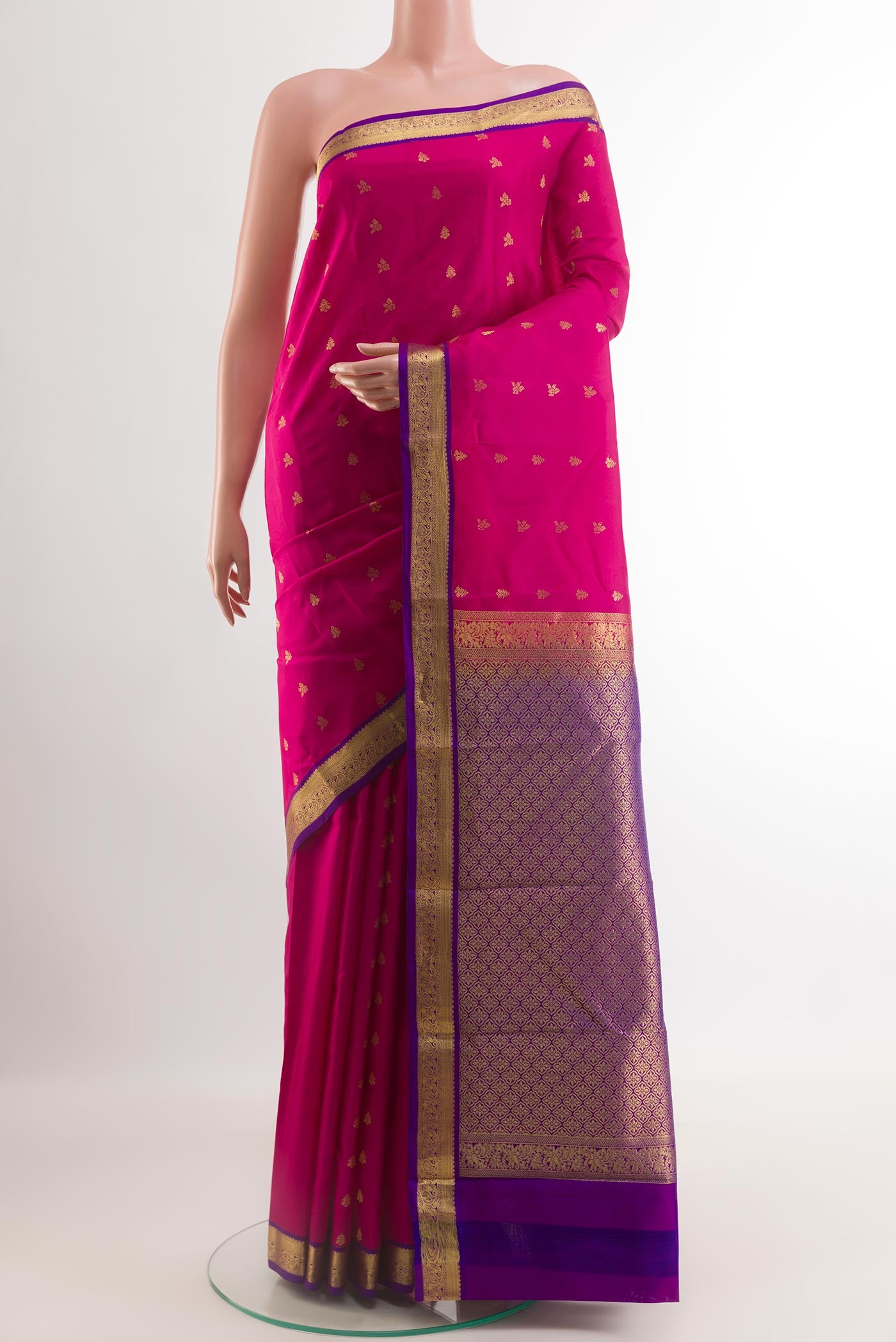 Pink Kanjivaram Silk Saree with Zari Butta on the body and Zari Border.  displayed on a mannequin