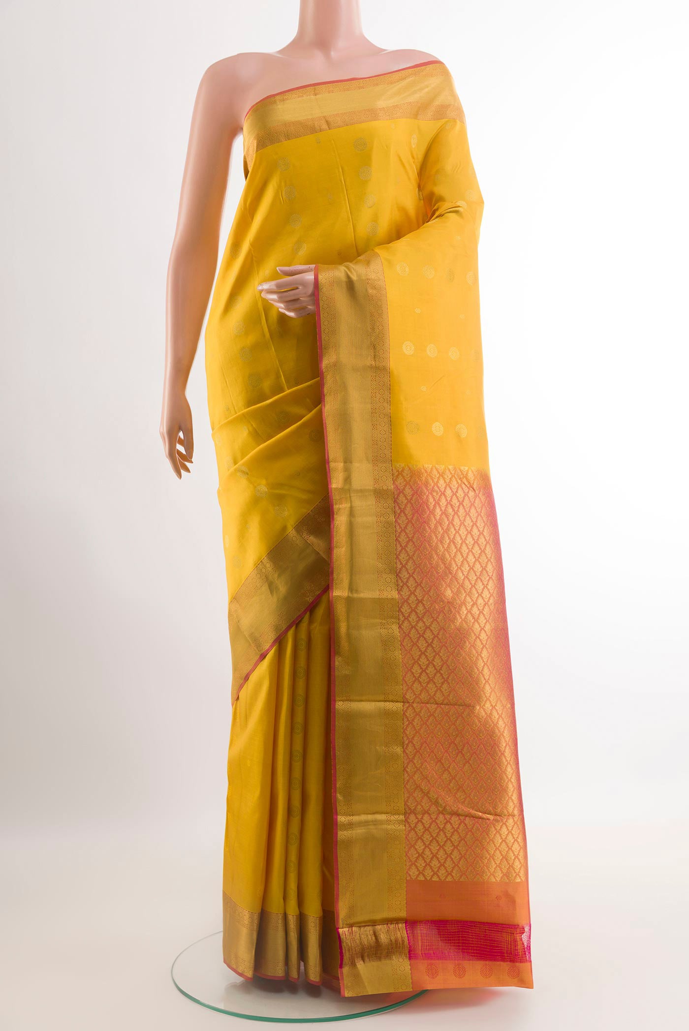 Yellow Kanjivaram Silk Saree with Zari Butta on the body and Zari Border.  displayed on a mannequin