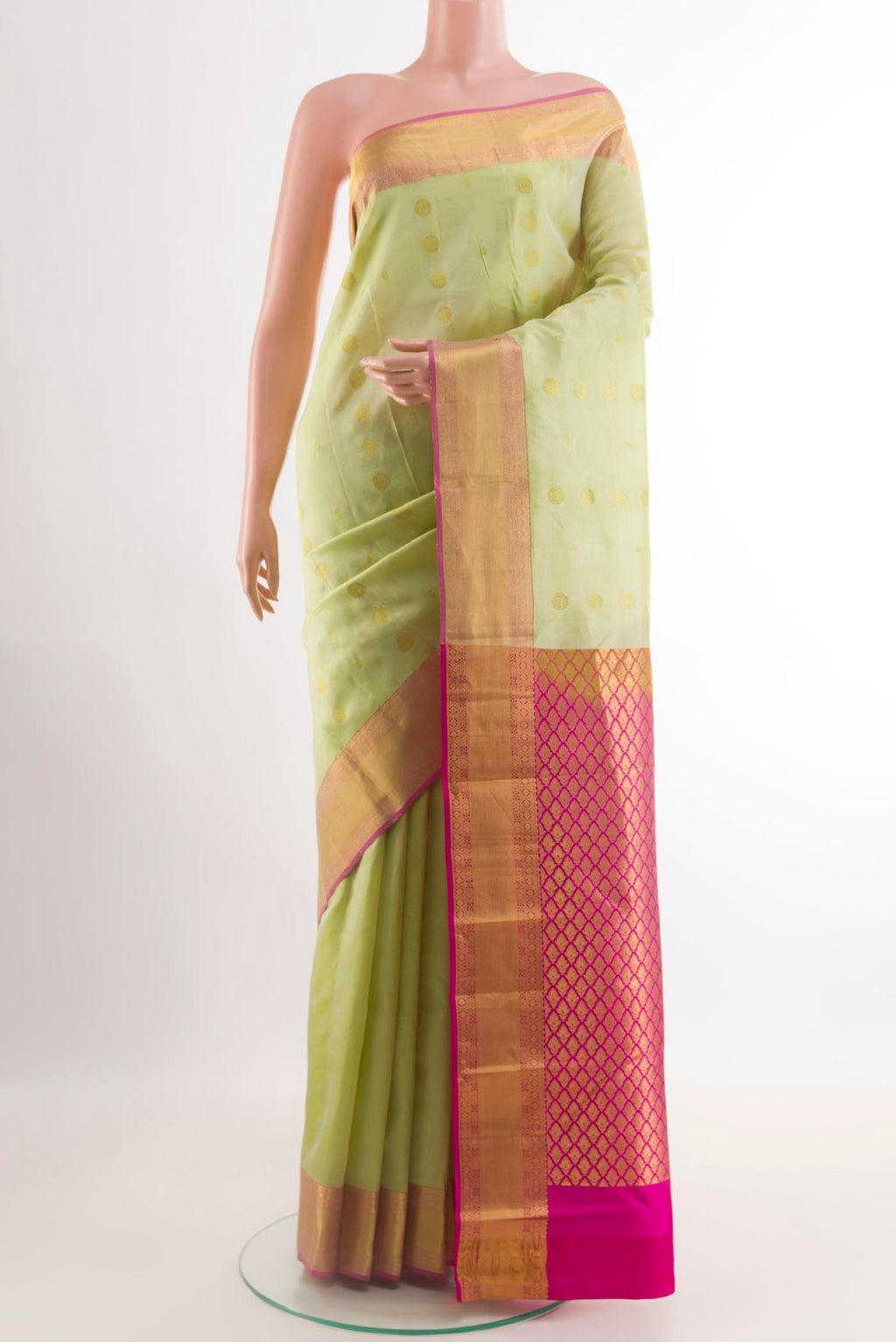 Light Green Kanjivaram Silk Saree with Zari Butta on the body and Zari Border.  displayed on a mannequin