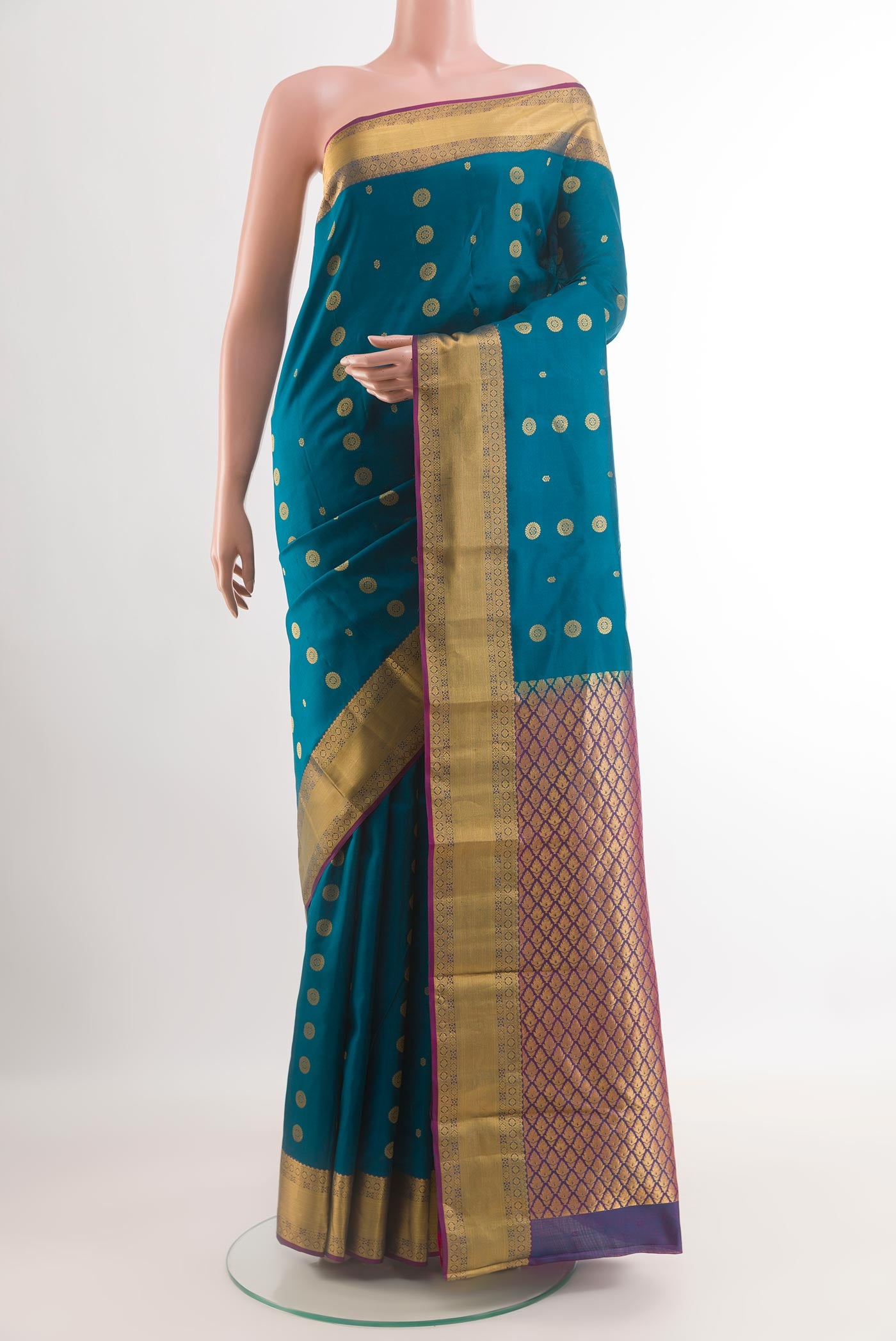 Blue Kanjivaram Silk Saree with Zari Butta on the body and Zari Border.  displayed on a mannequin