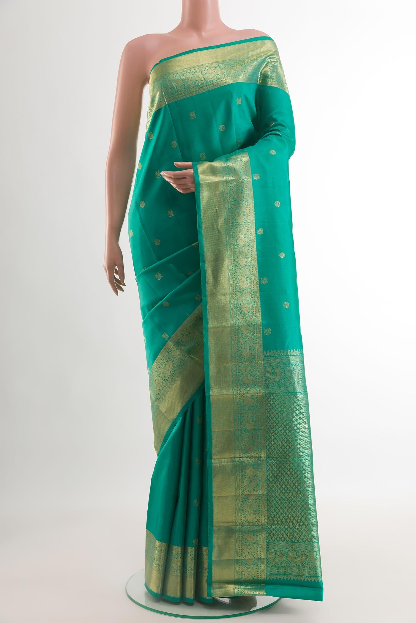 Sea Green Kanchipuram Silk Saree with Zari Butta on the body and Zari Border.  displayed on a mannequin