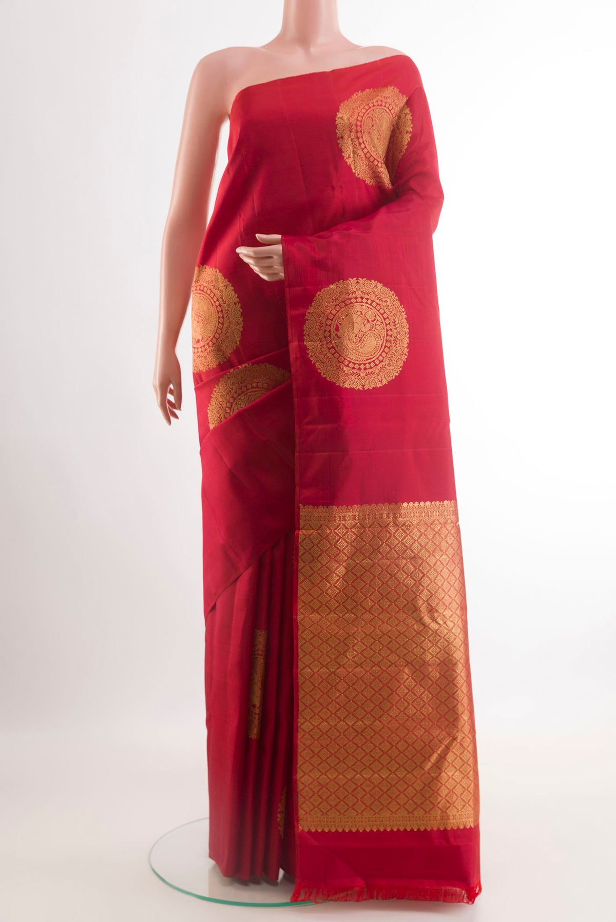 Red Kanchipuram Silk Saree with Zari Butta on the body and Zari Border.  displayed on a mannequin
