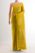 Mustard Kanchipuram Silk Saree with Zari Butta on the body and Without Border.  displayed on a mannequin