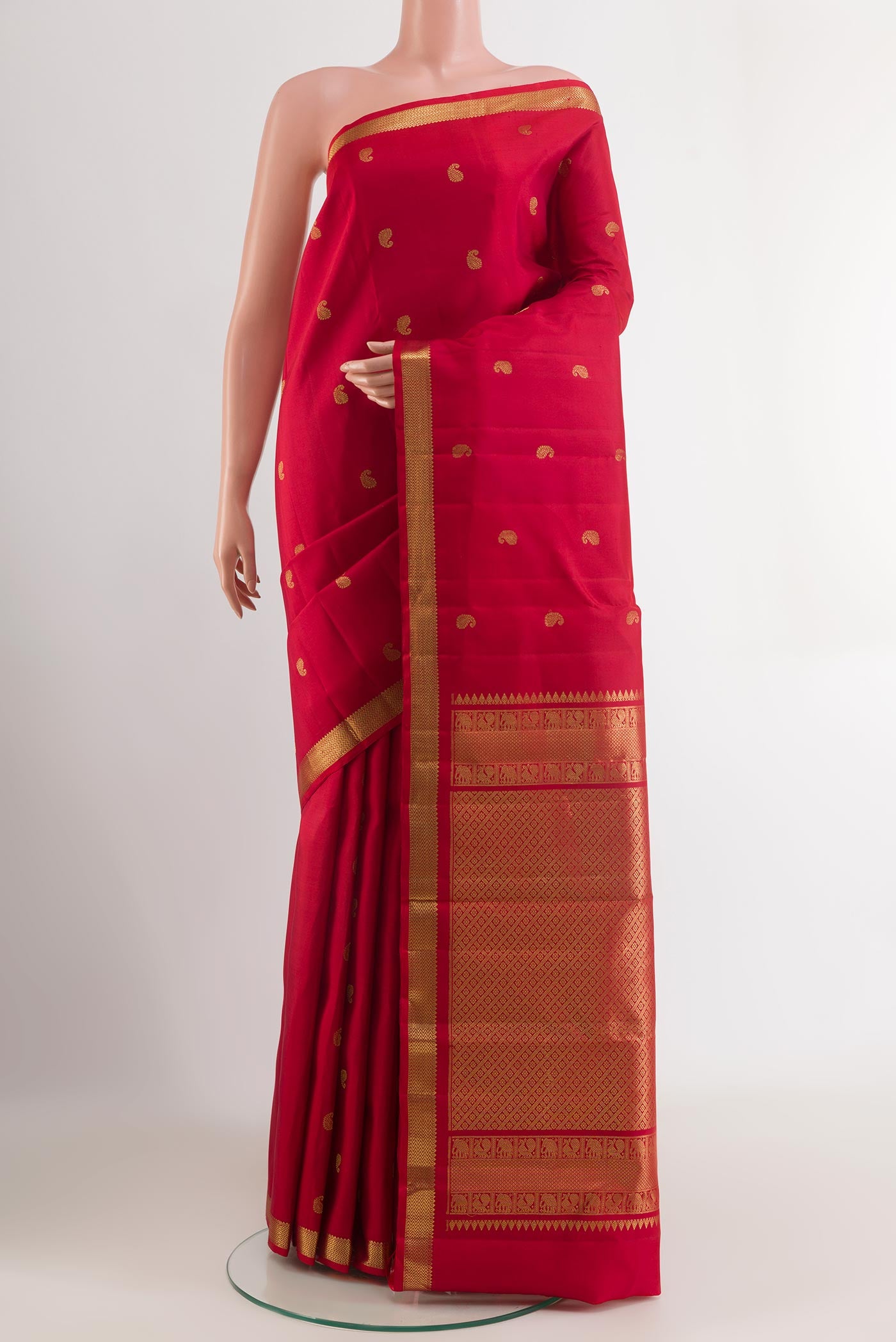Red Kanchipuram Silk Saree with Zari Butta on the body and Zari Border.  displayed on a mannequin