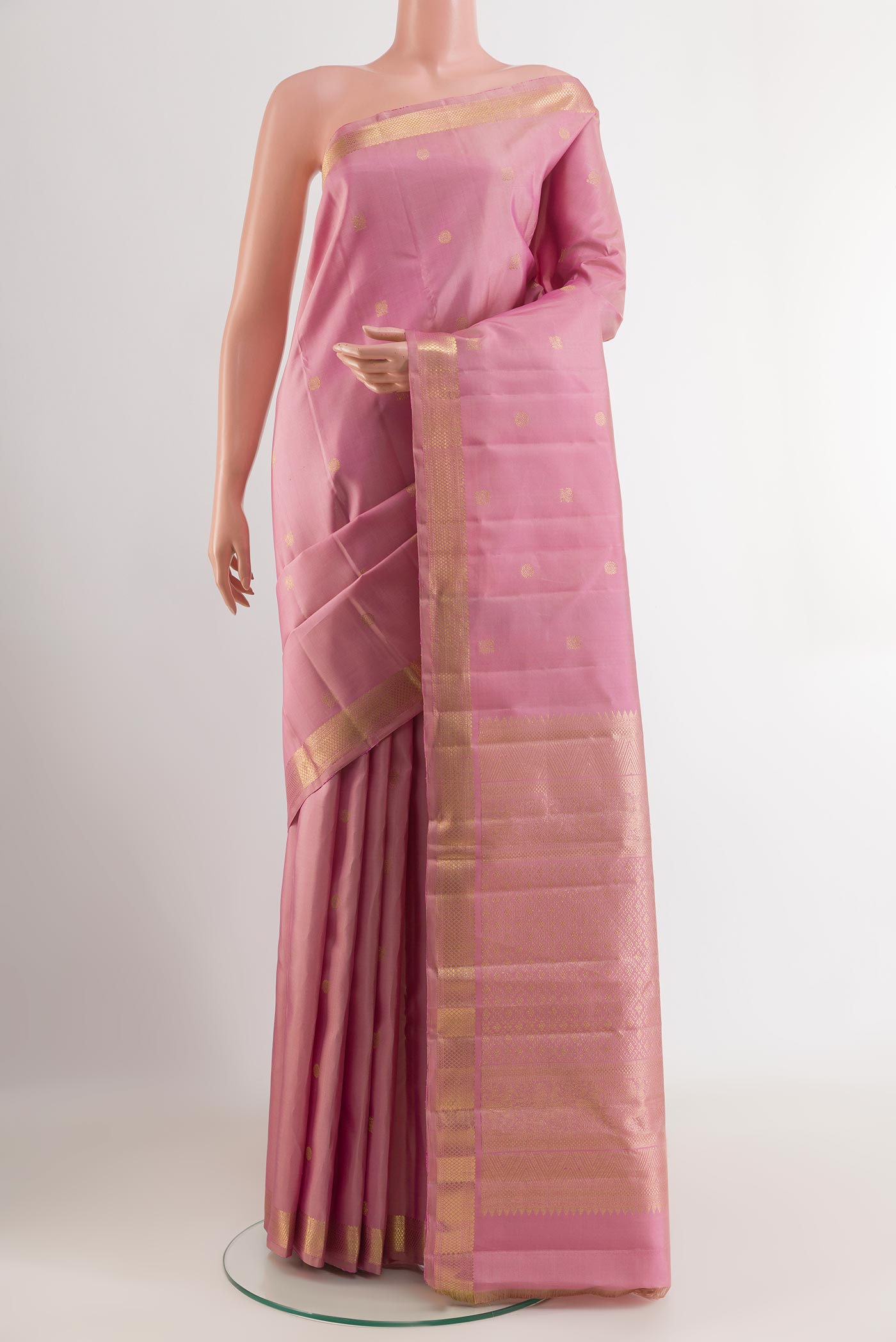 Pink Kanchipuram Silk Saree with Zari Butta on the body and Zari Border.  displayed on a mannequin