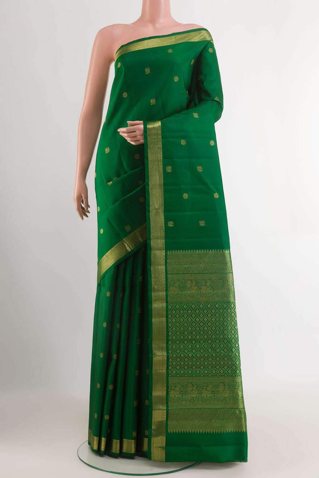 Green Kanchipuram Silk Saree with Zari Butta on the body and Zari Border.  displayed on a mannequin