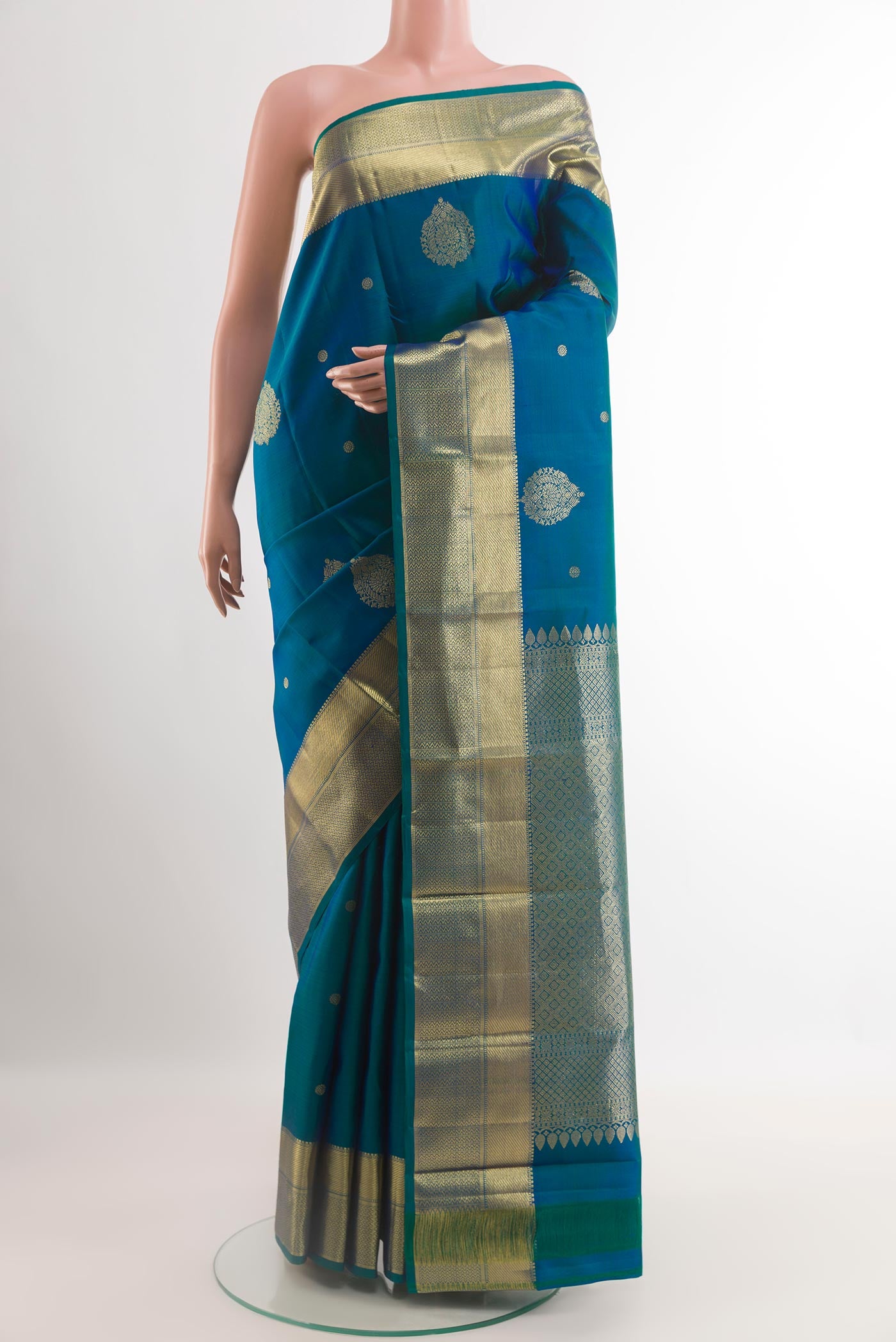 Blue Kanchipuram Silk Saree with Zari Butta on the body and Zari Border.  displayed on a mannequin