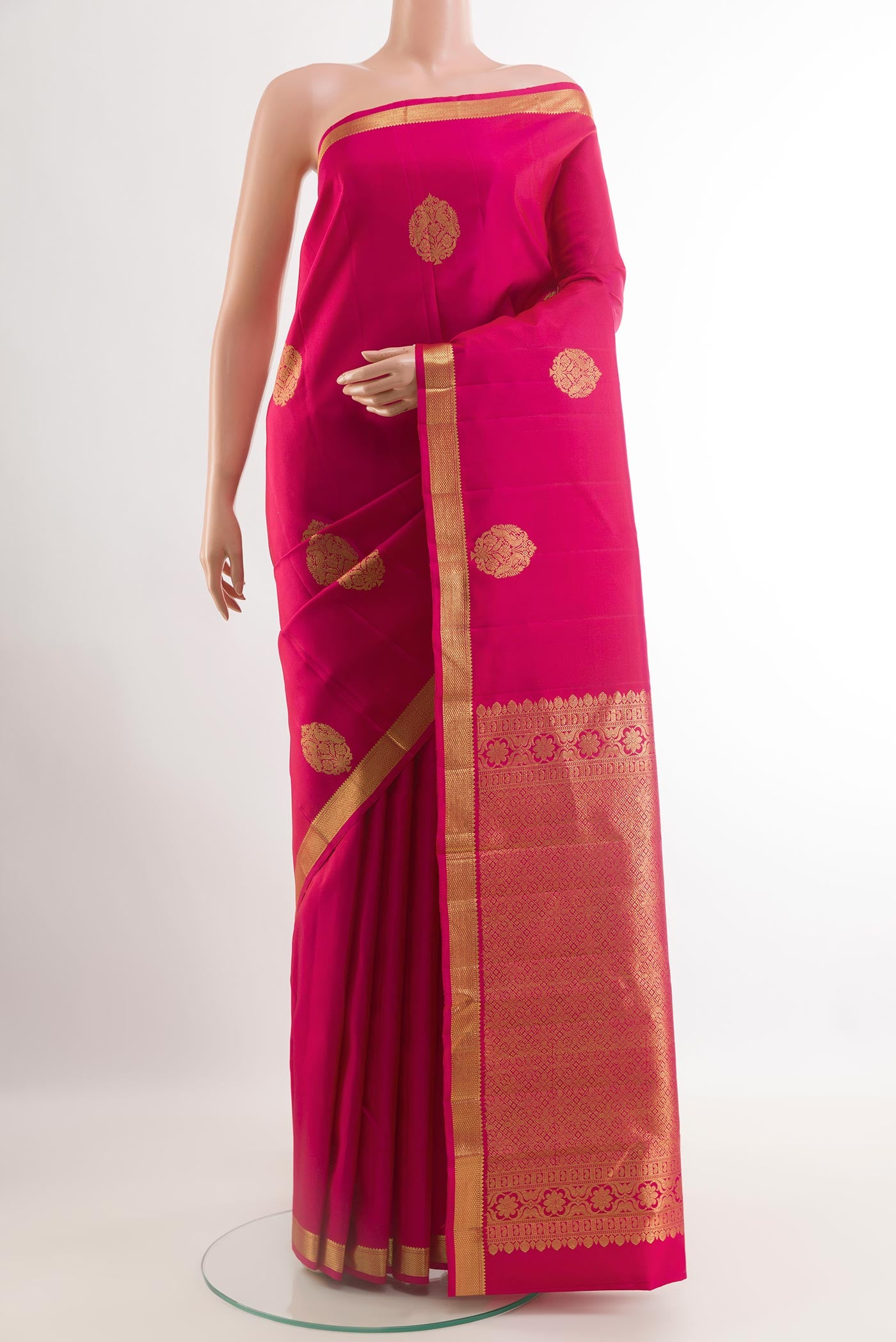 Pink Kanchipuram Silk Saree with Zari Butta on the body and Zari Border.  displayed on a mannequin