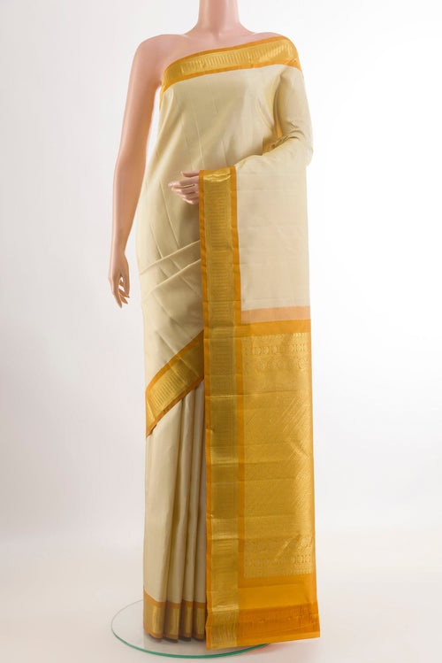 Cream Kanjivaram Silk Saree with Plain Body and Zari Border.  displayed on a mannequin