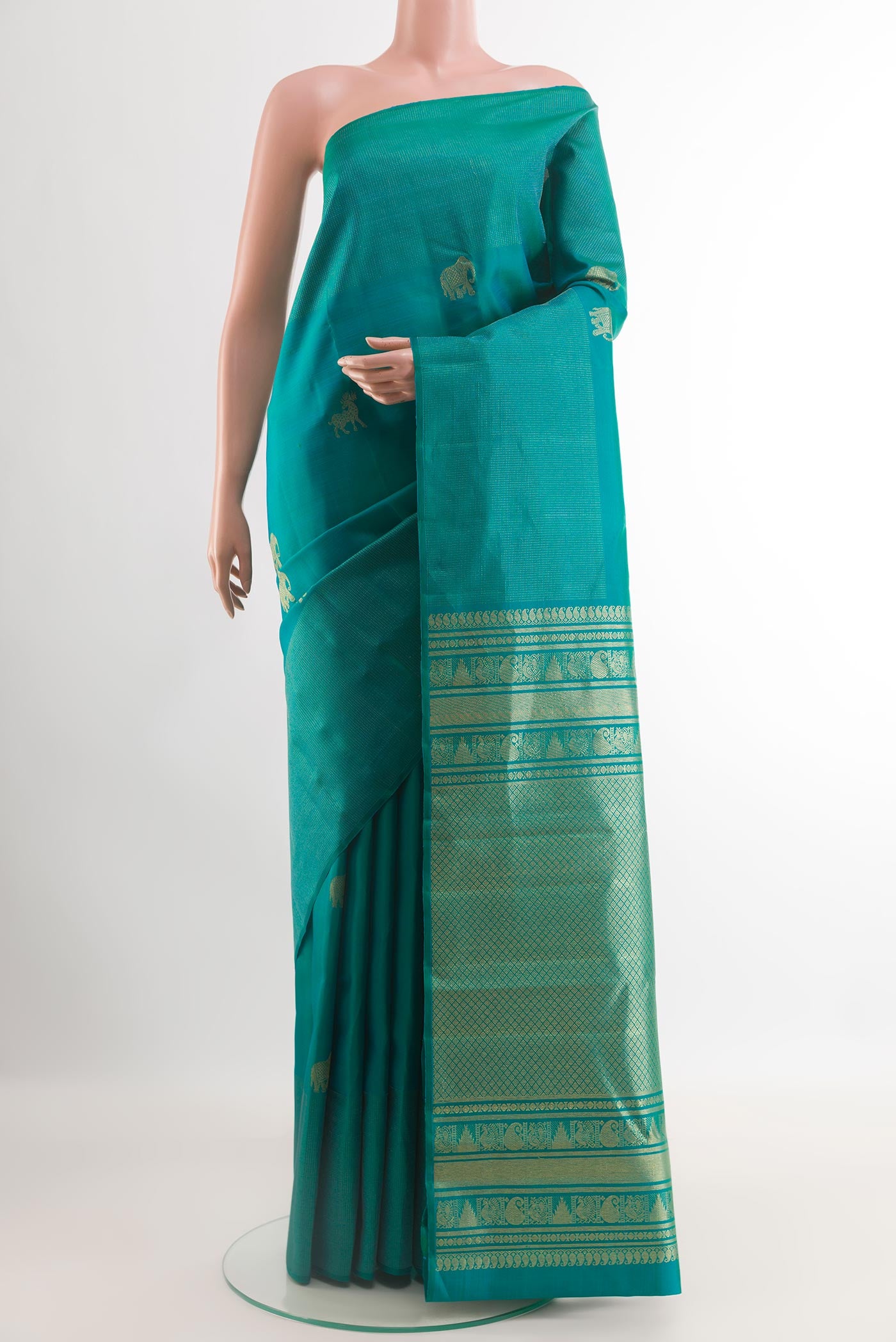 Sea Green Kanjivaram Silk Saree with Zari Butta on the body and Zari Border.  displayed on a mannequin
