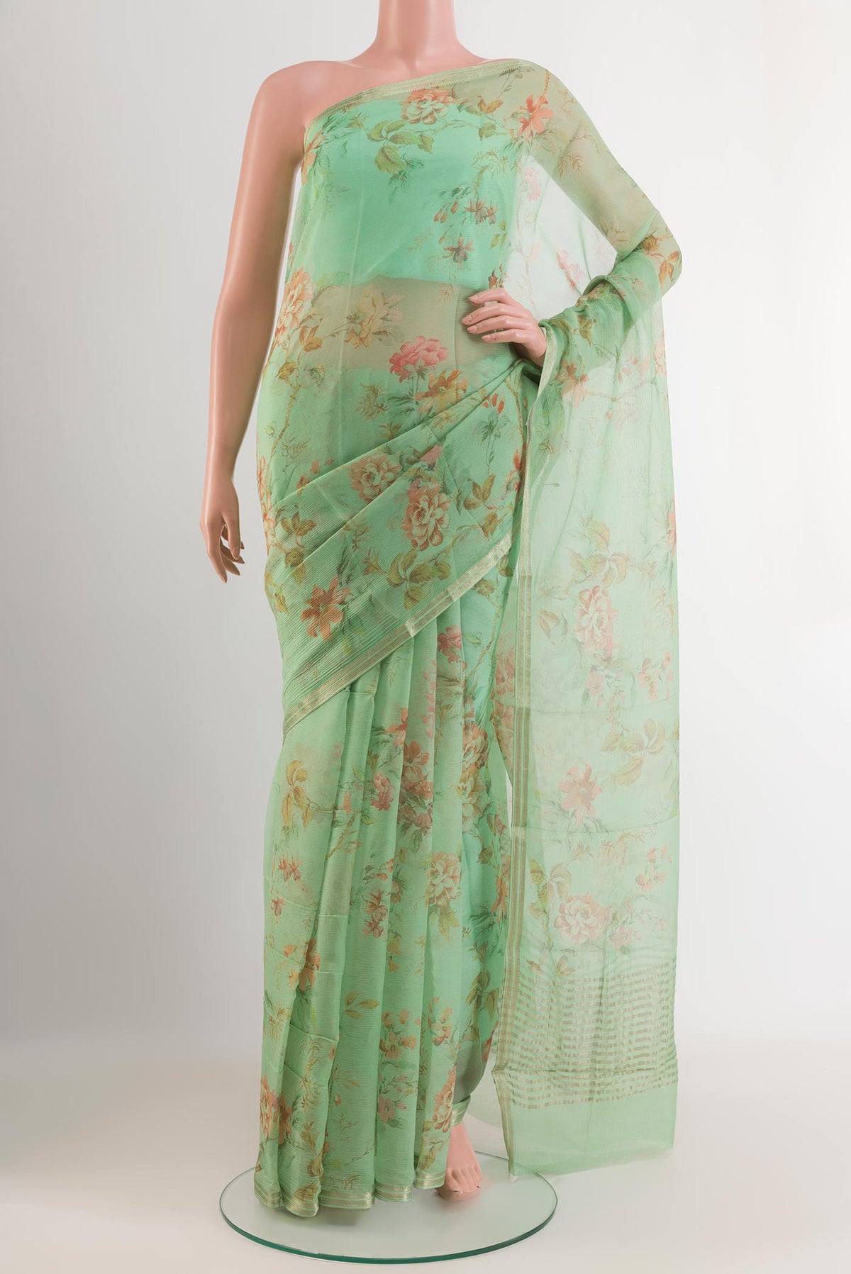 Green Mysore Chiffon Saree with Printed design on the body and Zari Border.  displayed on a mannequin