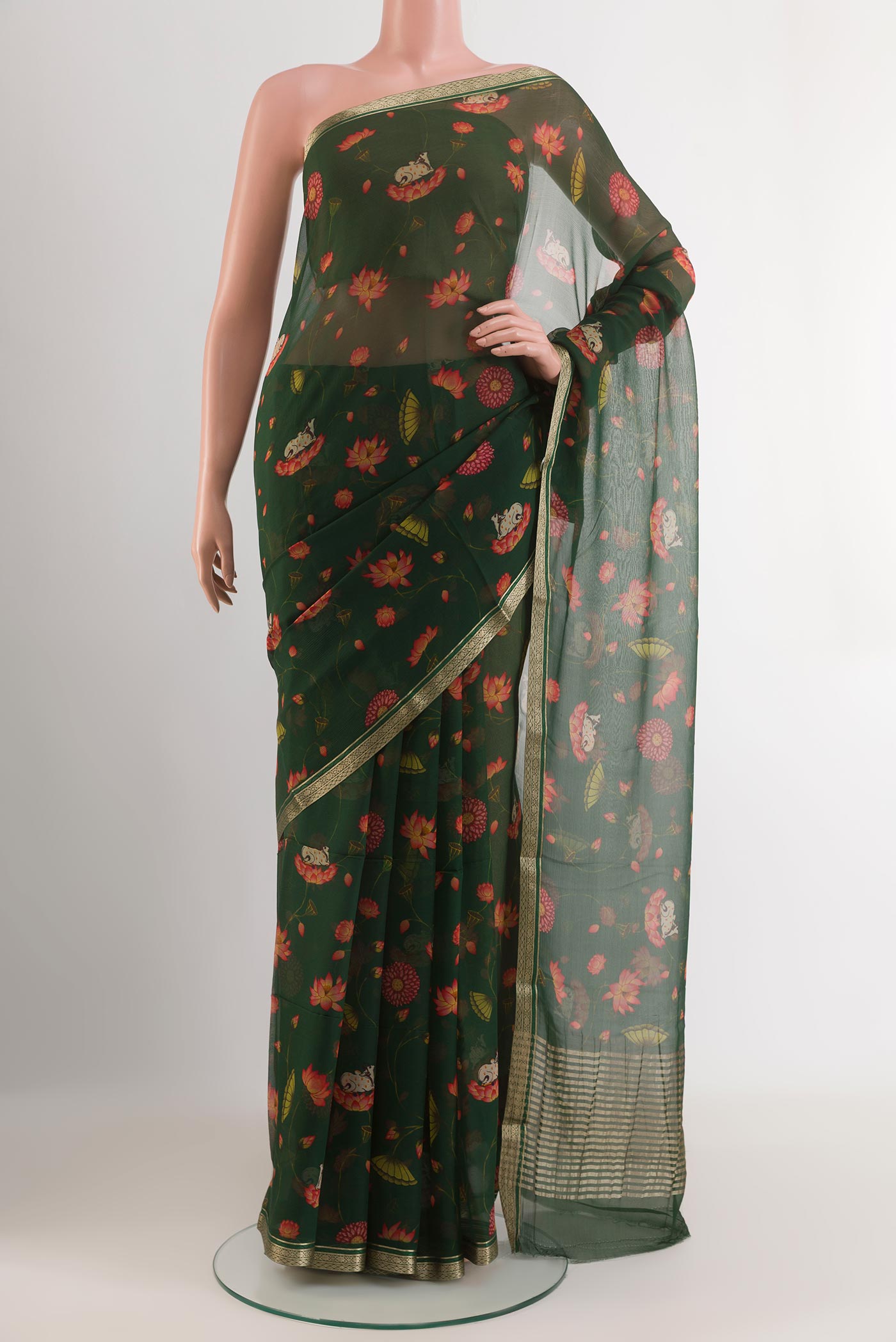 Green Mysore Chiffon Saree with Printed design on the body and Zari Border.  displayed on a mannequin