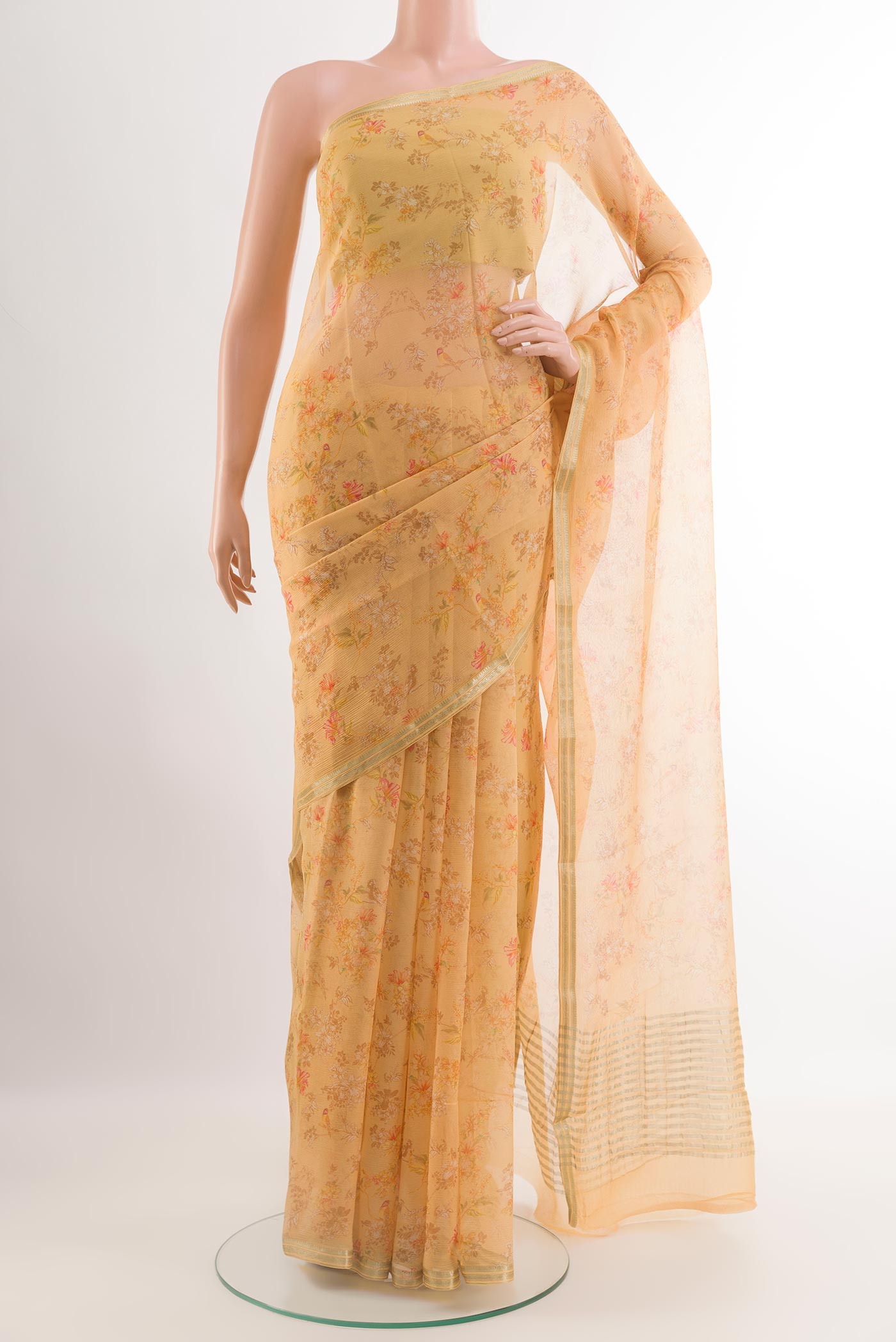 Peach Chiffon Saree with Printed design on the body and Zari Border.  displayed on a mannequin