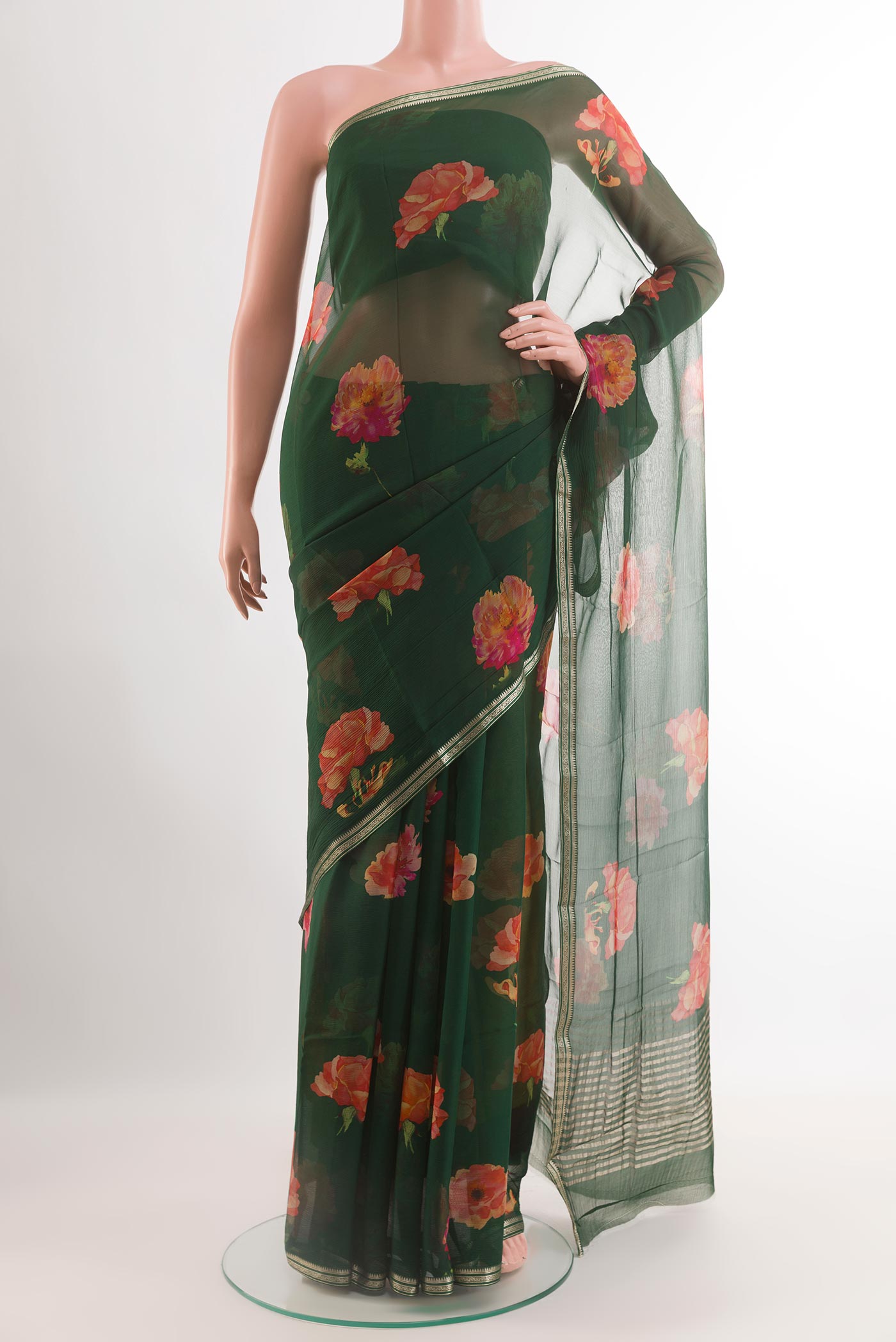 Green Chiffon Saree with Printed design on the body and Zari Border.  displayed on a mannequin