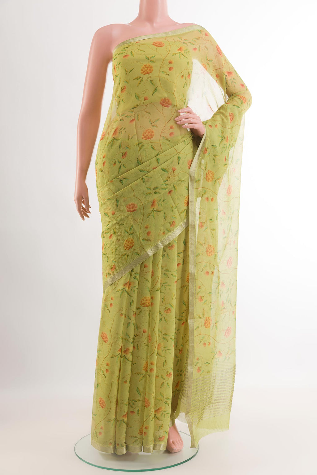 Green Chiffon Saree with Printed design on the body and Zari Border.  displayed on a mannequin