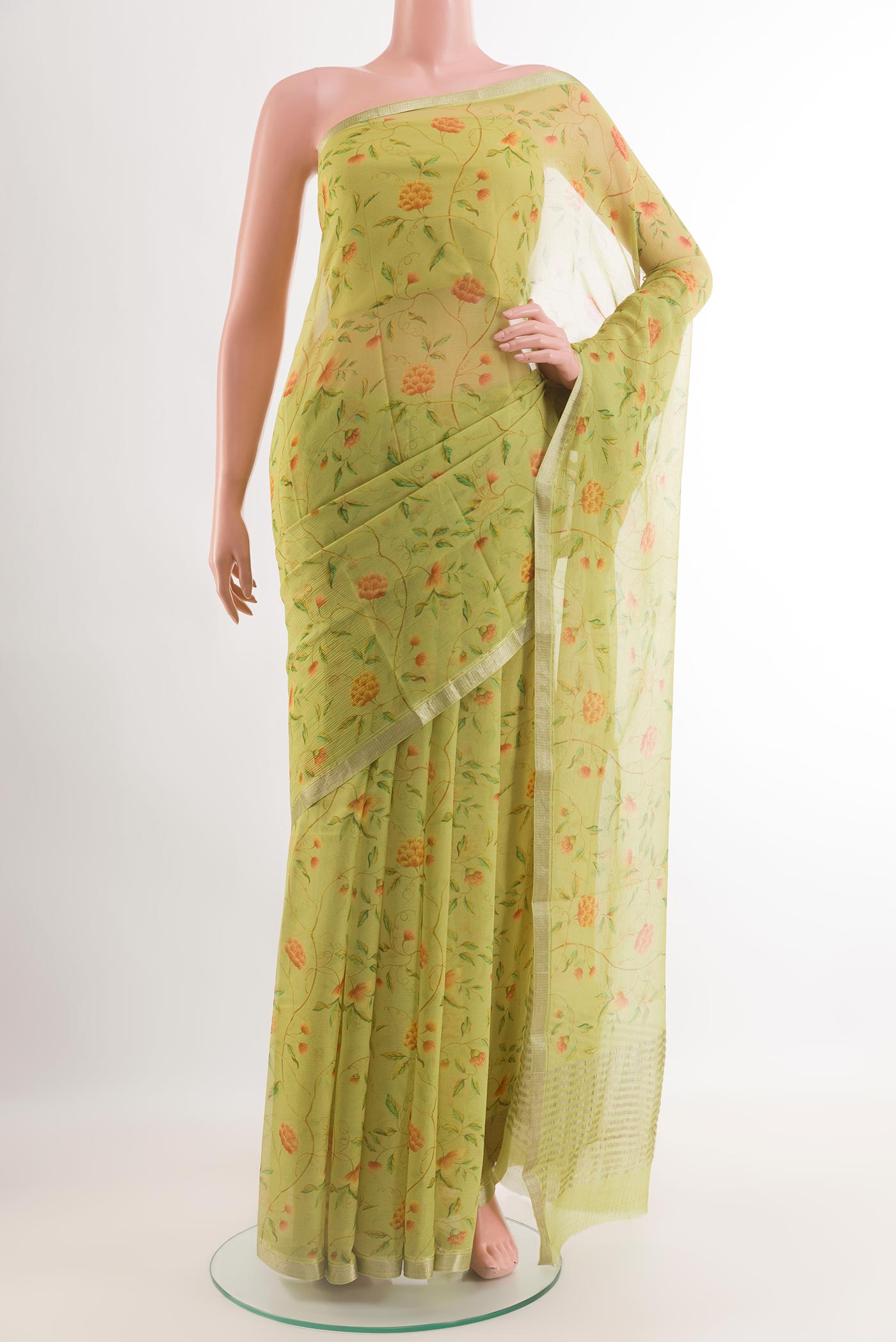 Green Chiffon Saree with Printed design on the body and Zari Border.  displayed on a mannequin