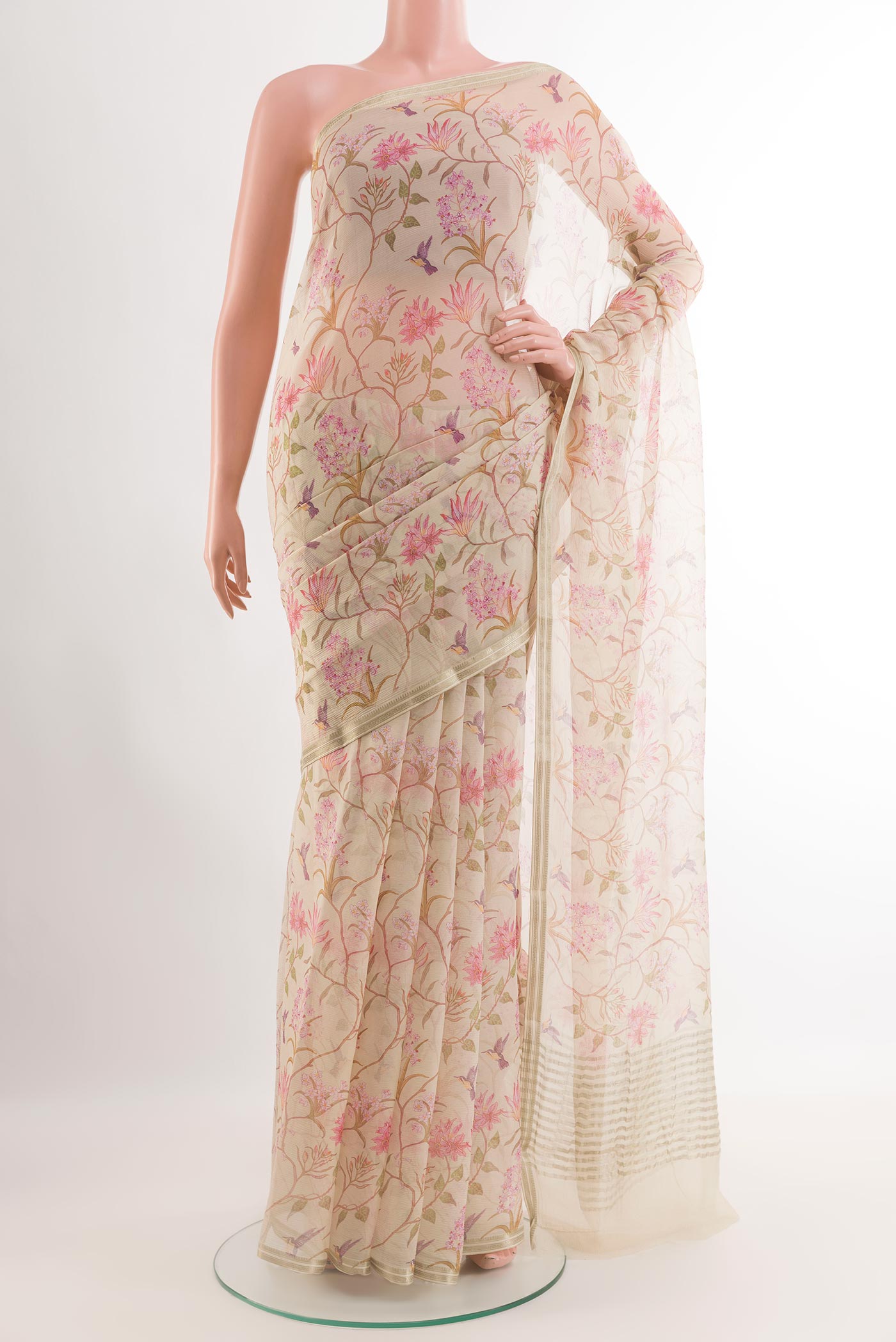 Off White Chiffon Saree with Printed design on the body and Zari Border.  displayed on a mannequin