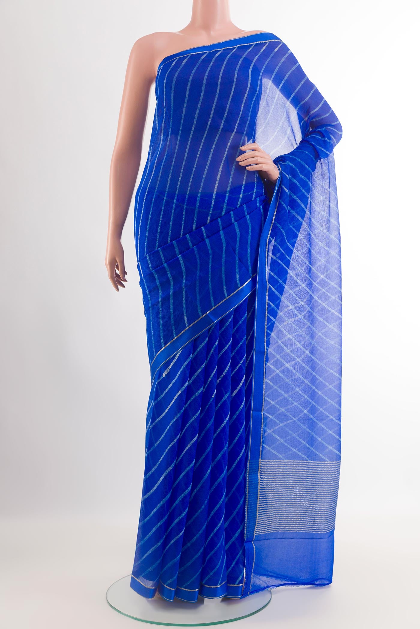 Blue Chiffon Saree with Stripes on the body and Zari Border.  displayed on a mannequin