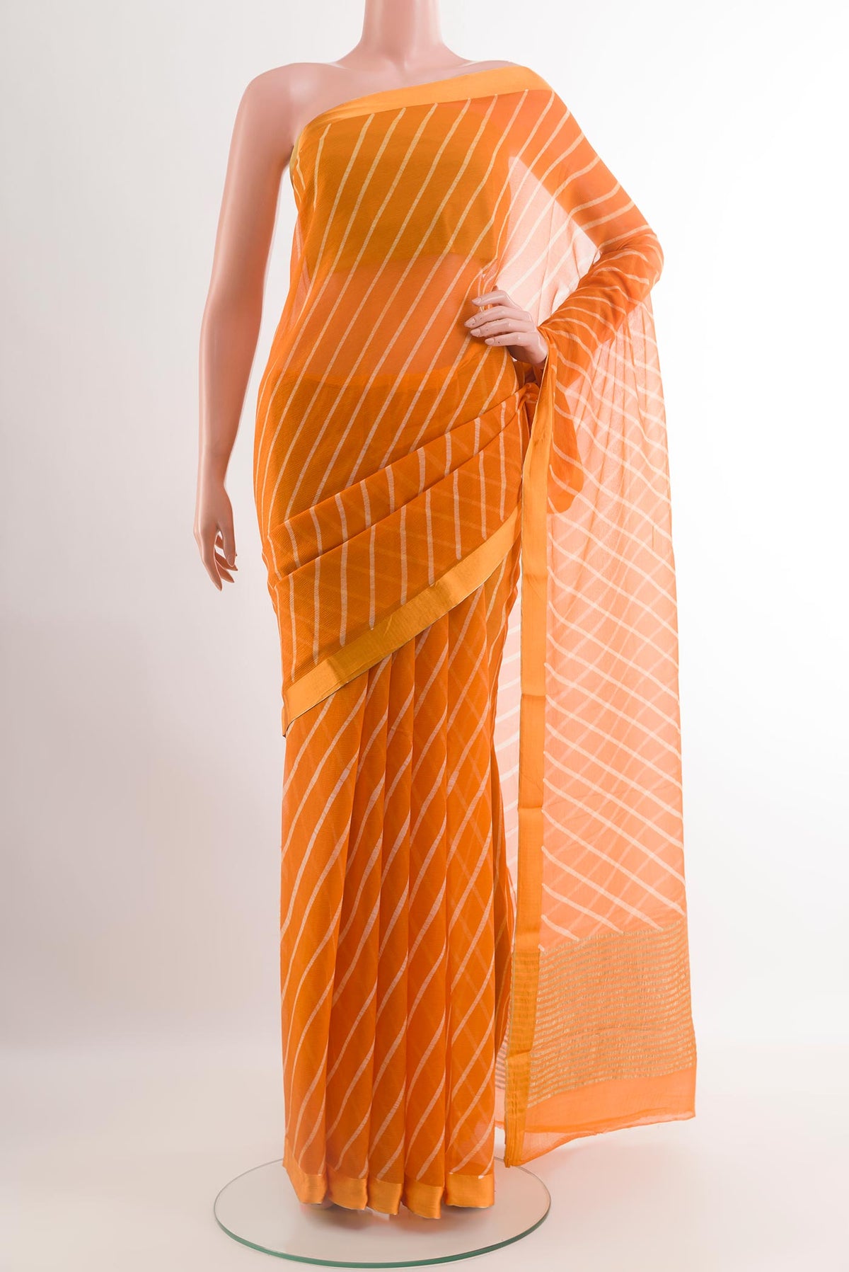 Orange Chiffon Saree with Stripes on the body and Zari Border.  displayed on a mannequin