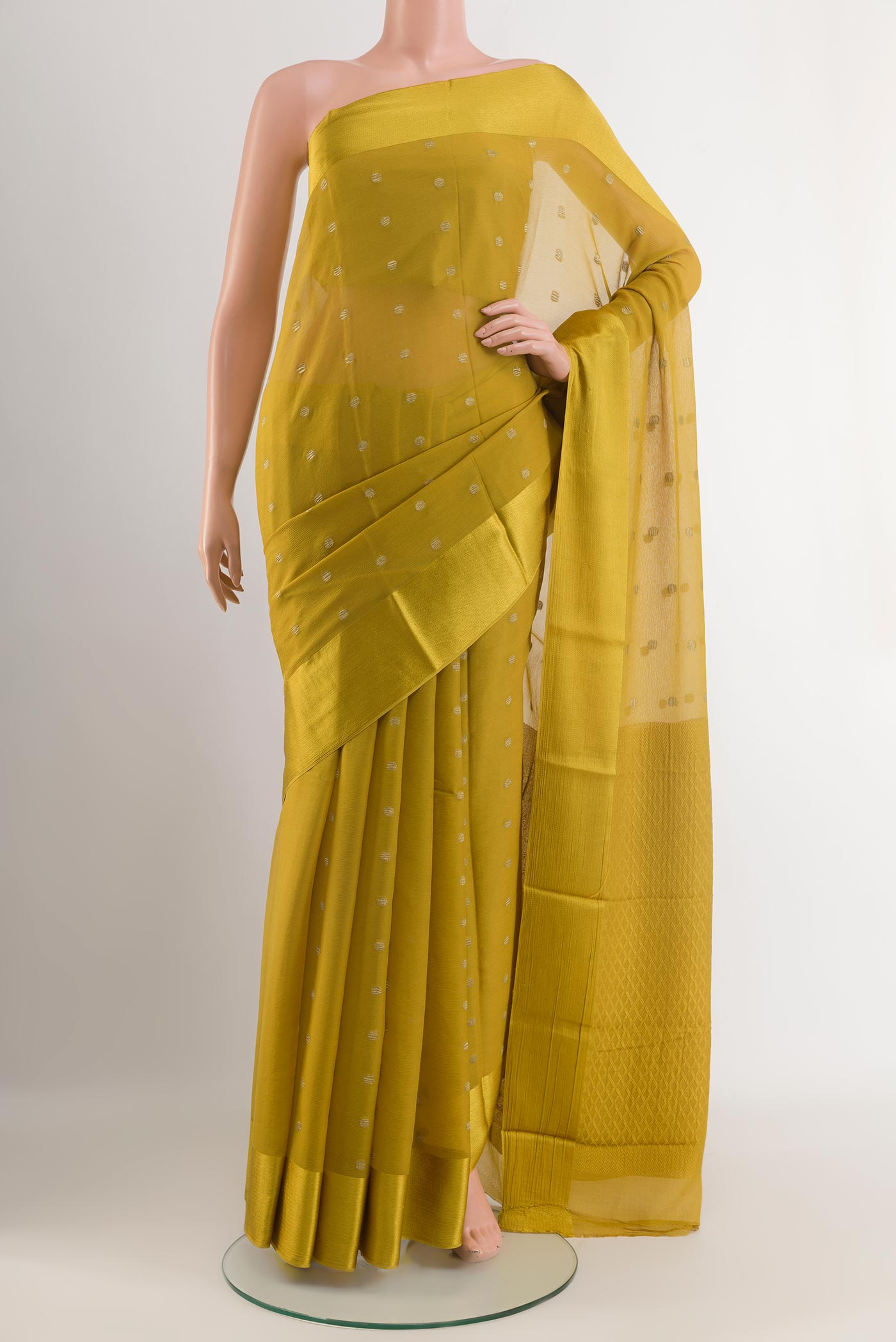 Yellow Mysore Chiffon Saree with Zari Butta on the body and Zari Border.  displayed on a mannequin
