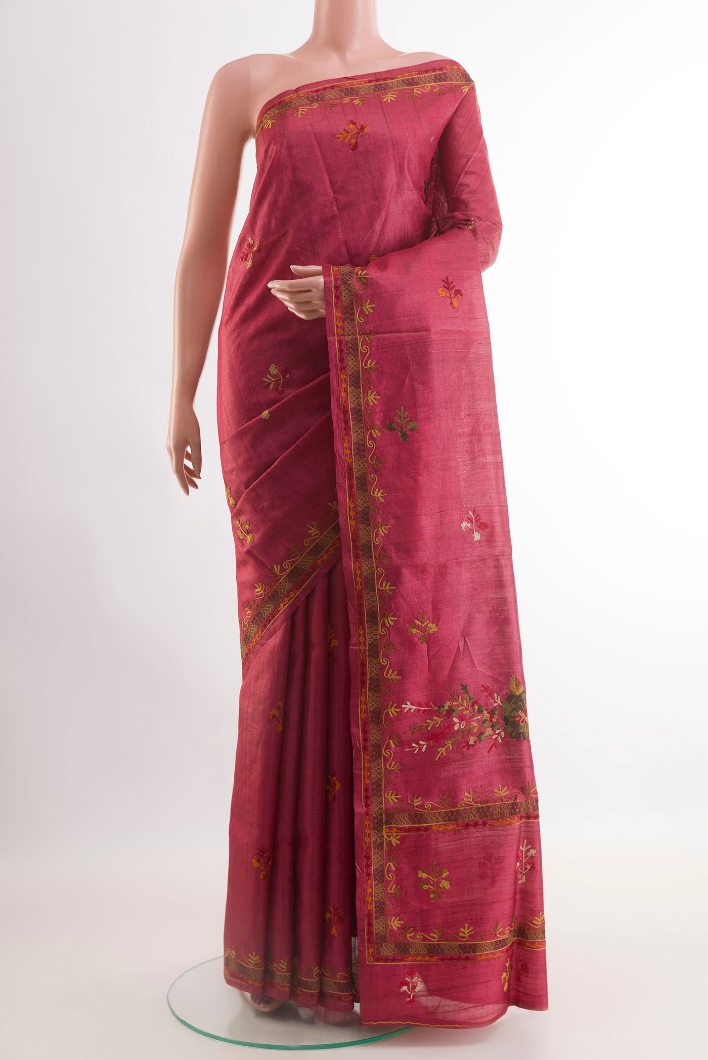 Red Tussar Saree with Embroidery on the body and Embroidery Border.  displayed on a mannequin