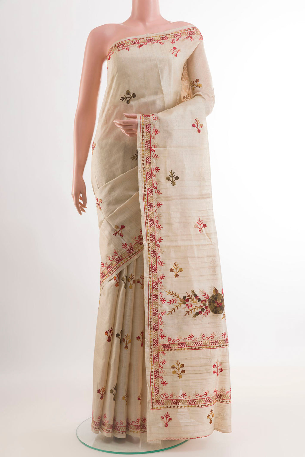 Off White Tussar Saree with Embroidery on the body and Embroidery Border.  displayed on a mannequin