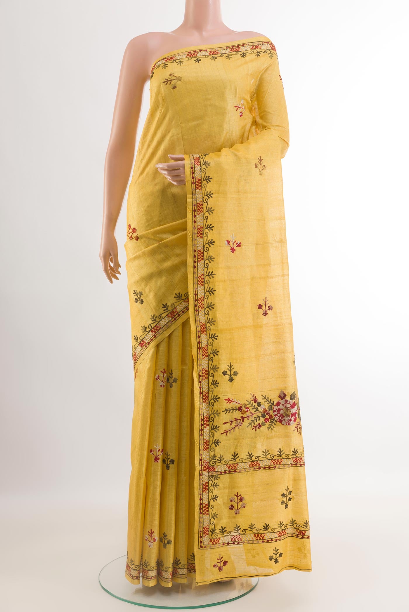 Yellow Tussar Saree with Embroidery on the body and Embroidery Border.  displayed on a mannequin