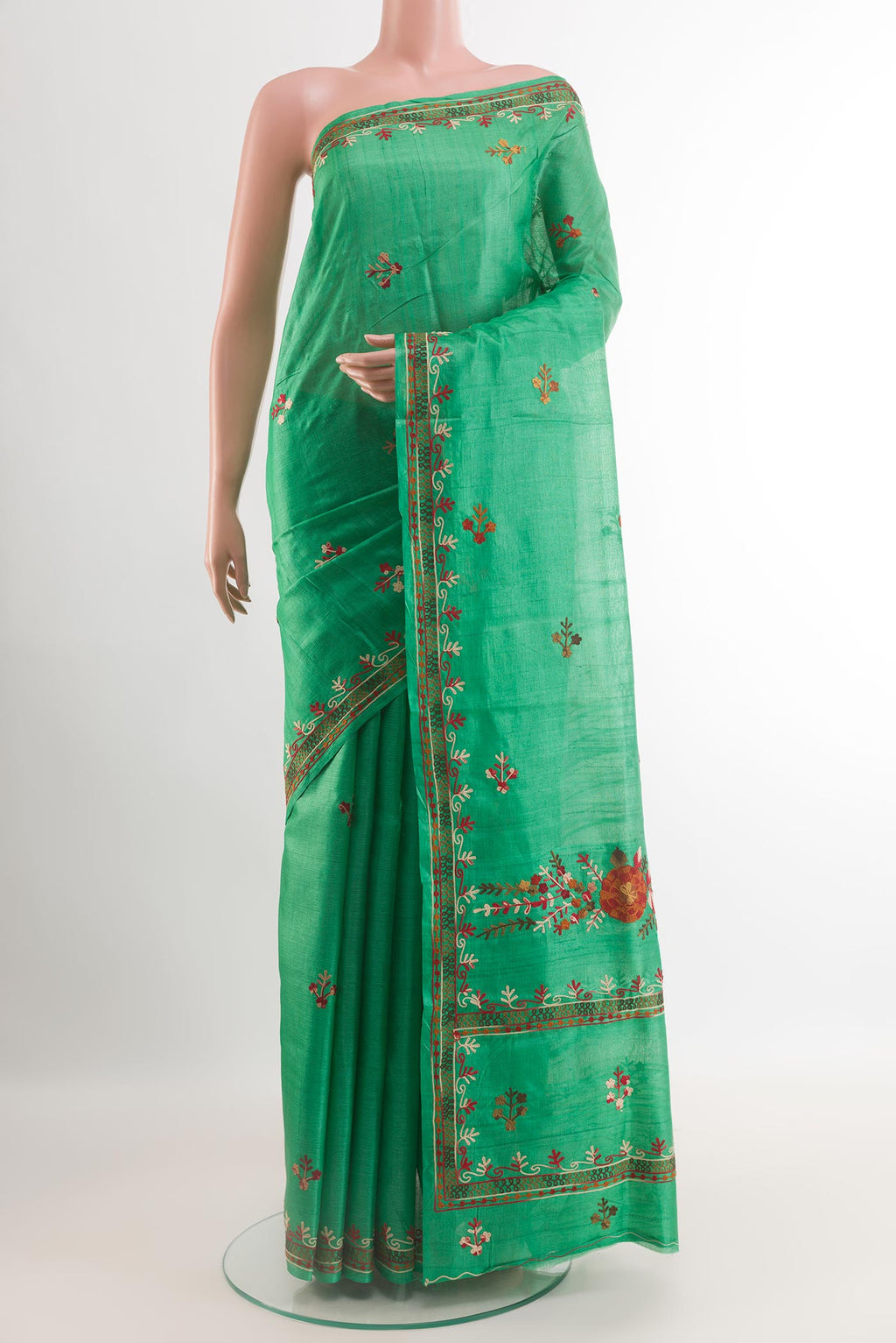 Green Tussar Saree with Embroidery on the body and Embroidery Border.  displayed on a mannequin
