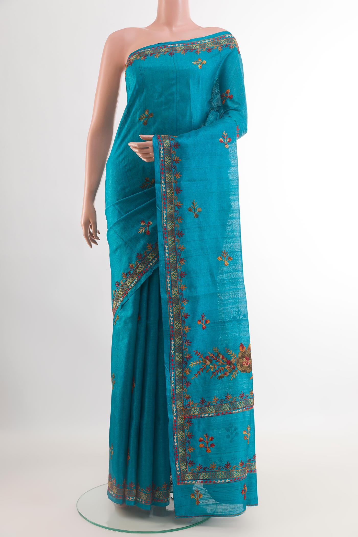 Blue Tussar Saree with Embroidery on the body and Embroidery Border.  displayed on a mannequin