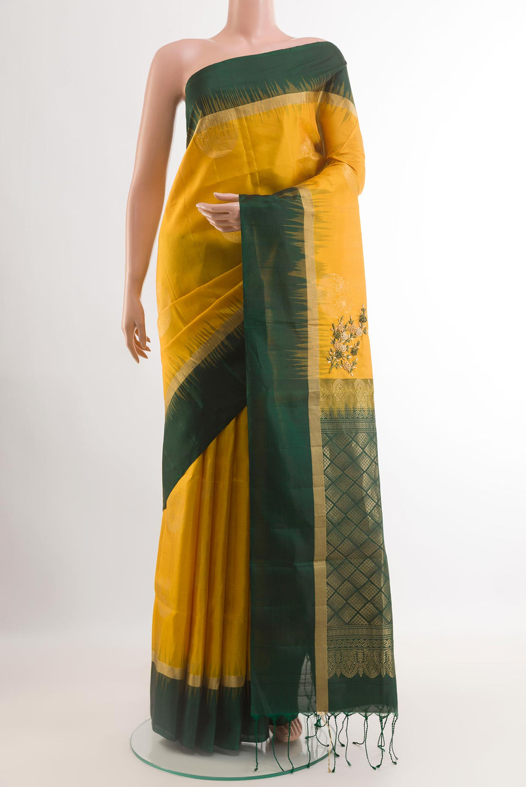 Yellow Soft Silk Saree with Zari Butta on the body and Zari Border.  displayed on a mannequin