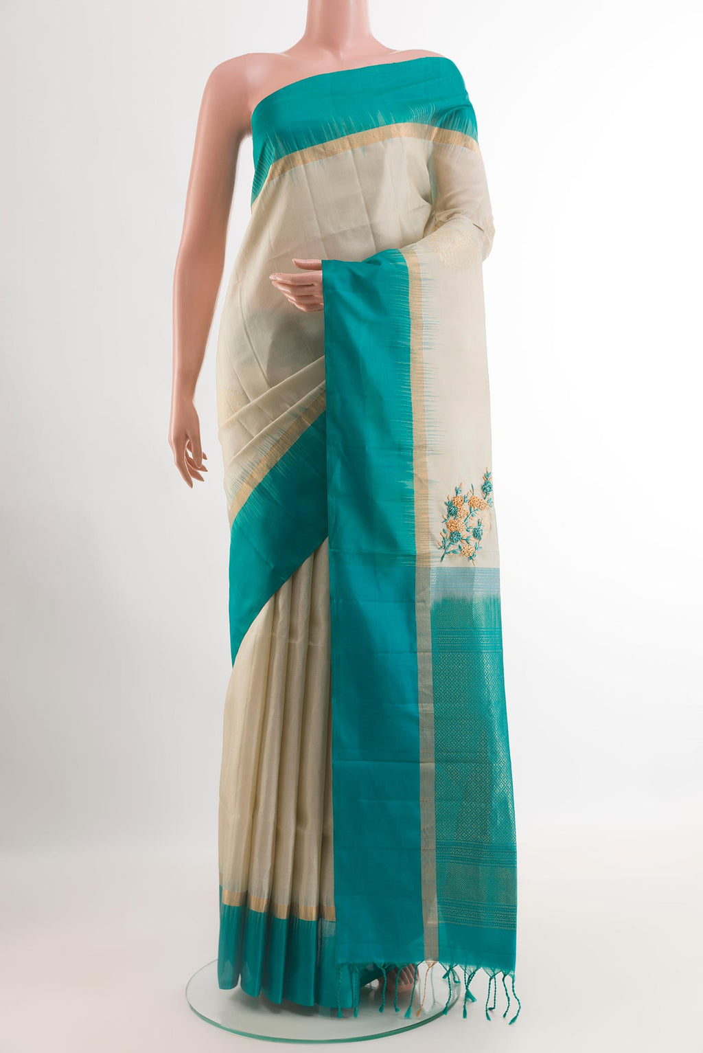Grey Soft Silk Saree with Zari Butta on the body and Zari Border.  displayed on a mannequin