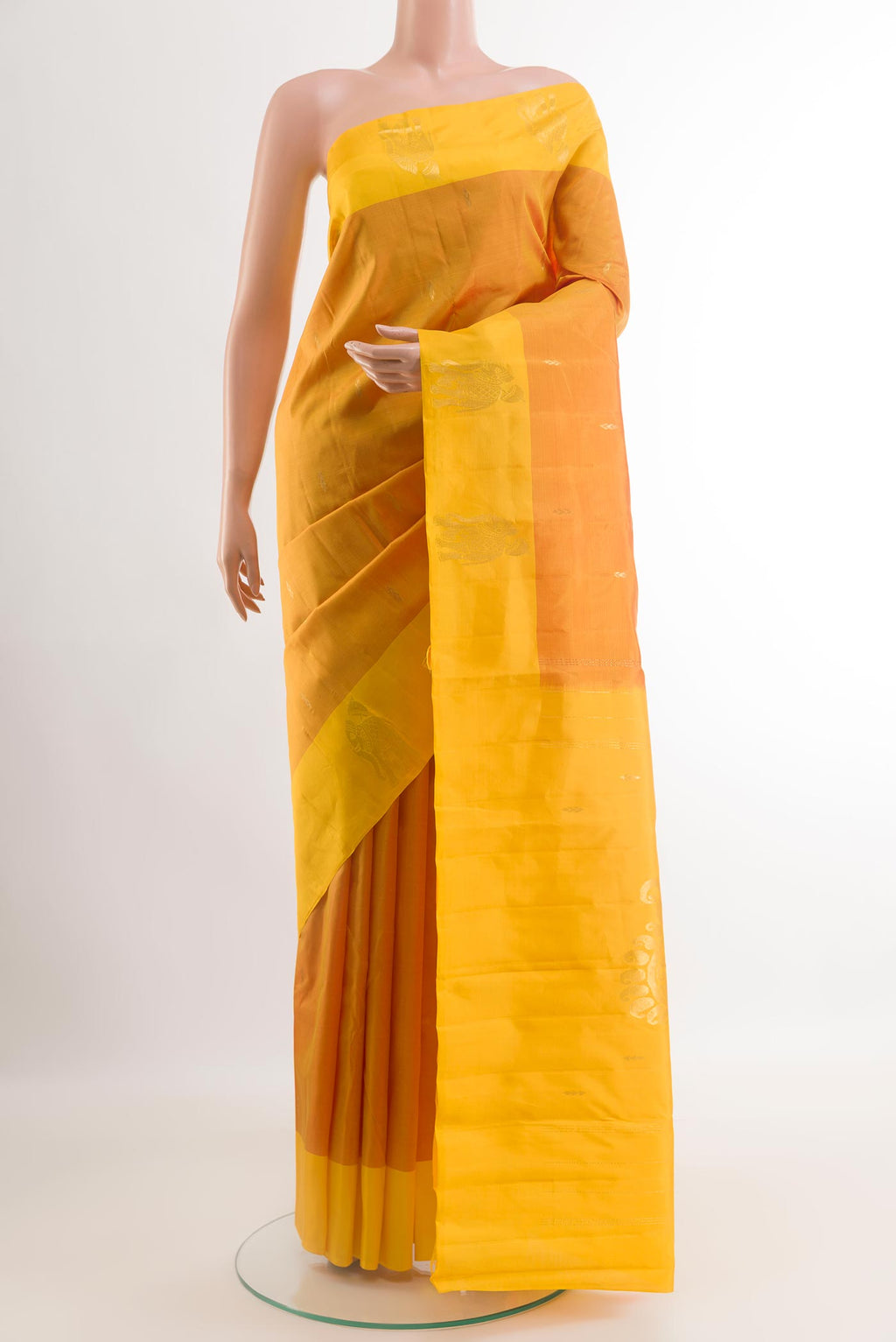Yellow Kanchipuram Silk Saree with Zari Butta on the body and Zari Border.  displayed on a mannequin