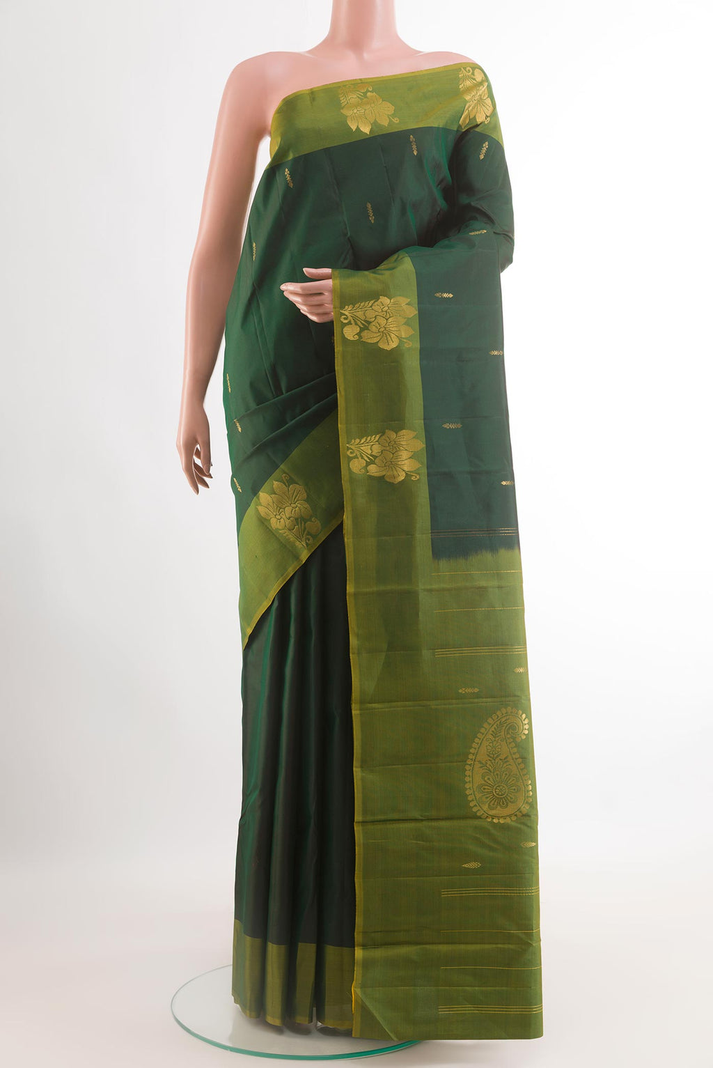 Bottle Green Kanchipuram Silk Saree with Zari Butta on the body and Zari Border.  displayed on a mannequin