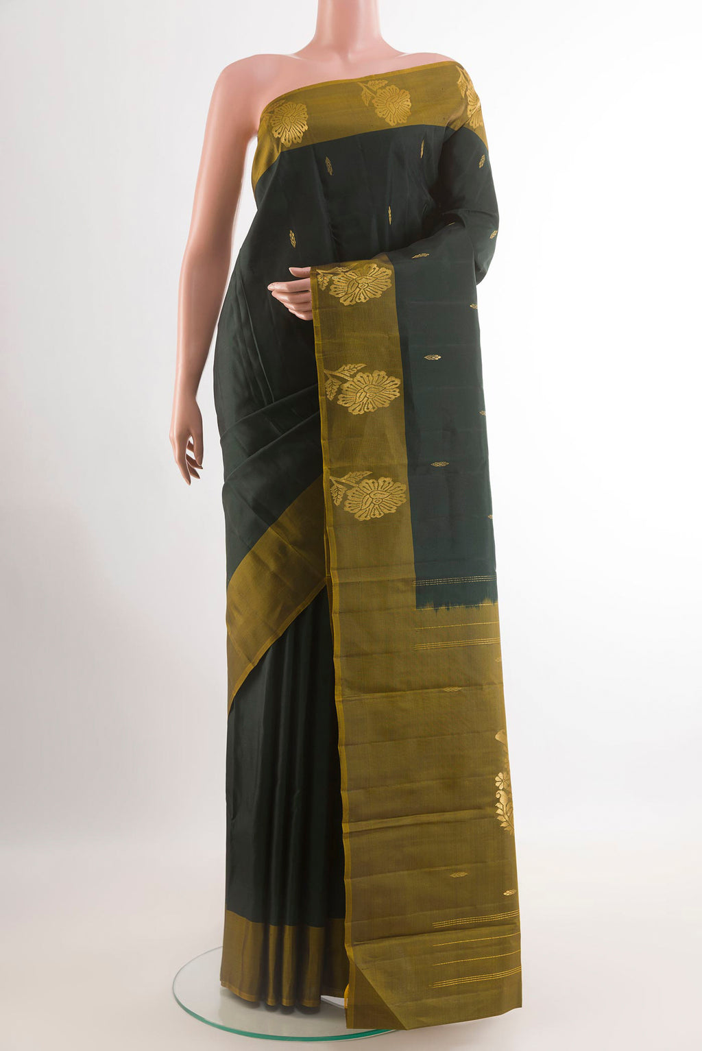 Bottle Green Kanchipuram Silk Saree with Zari Butta on the body and Zari Border.  displayed on a mannequin