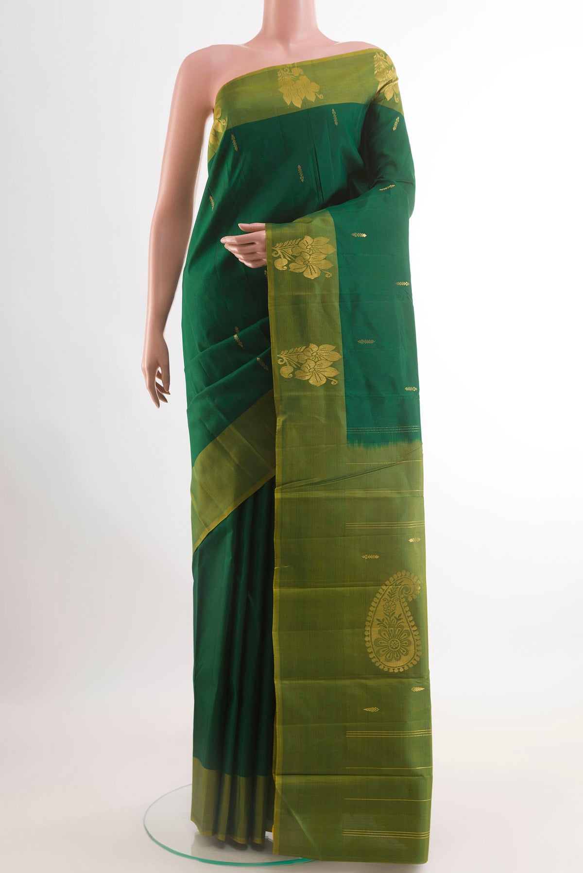 Bottle Green Kanchipuram Silk Saree with Zari Butta on the body and Zari Border.  displayed on a mannequin