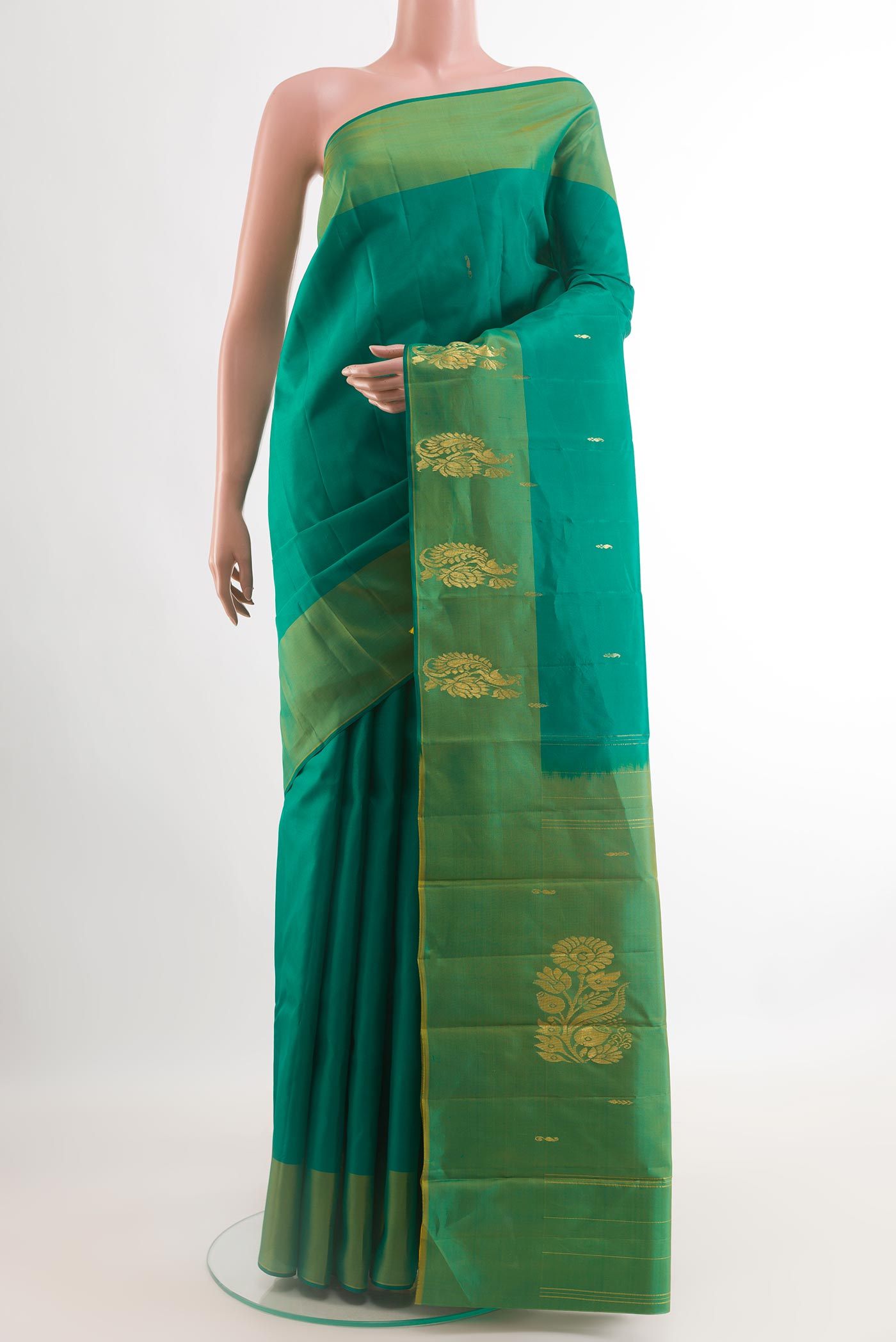 Green Kanchipuram Silk Saree with Zari Butta on the body and Zari Border.  displayed on a mannequin