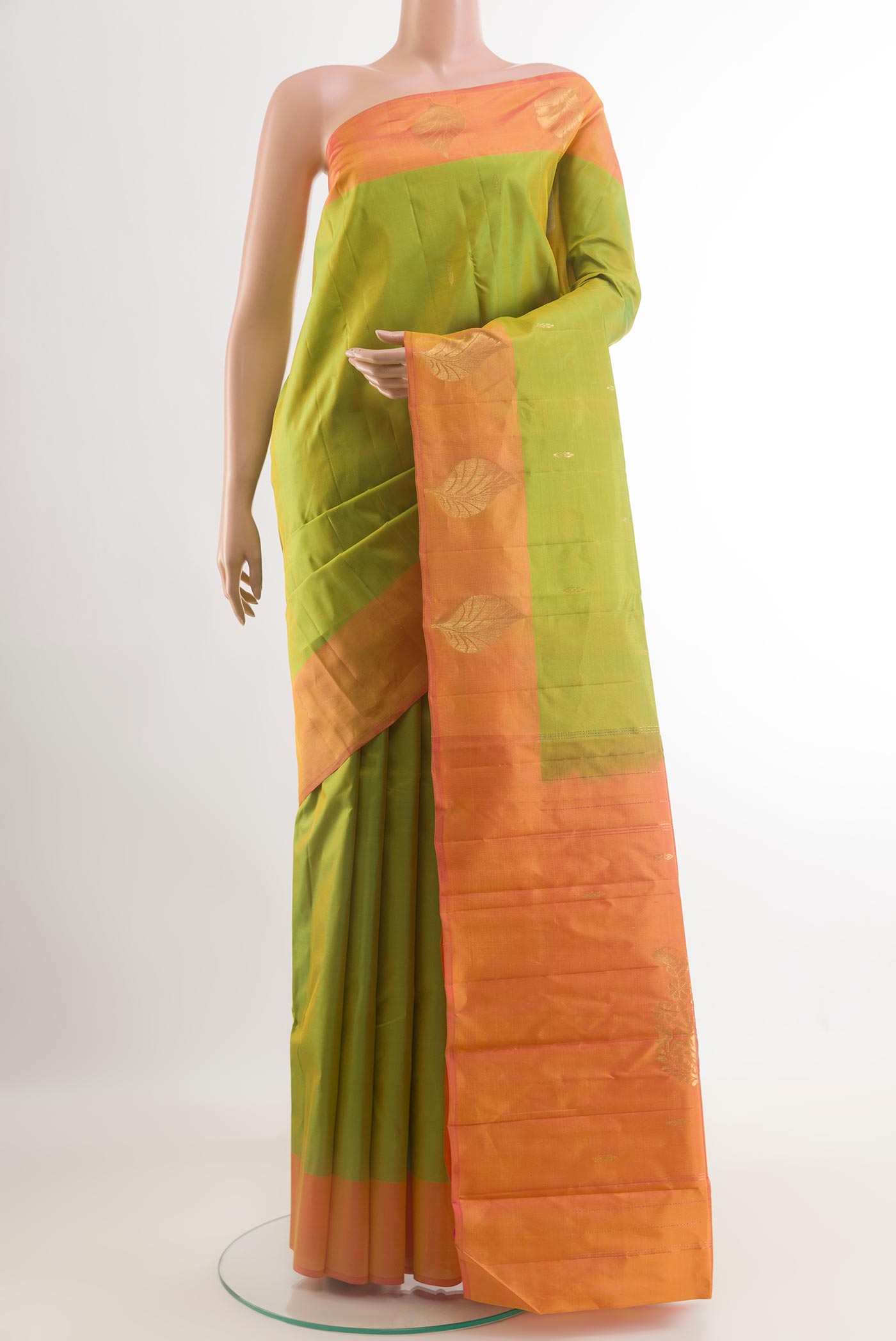 Green Kanchipuram Silk Saree with Zari Butta on the body and Zari Border.  displayed on a mannequin