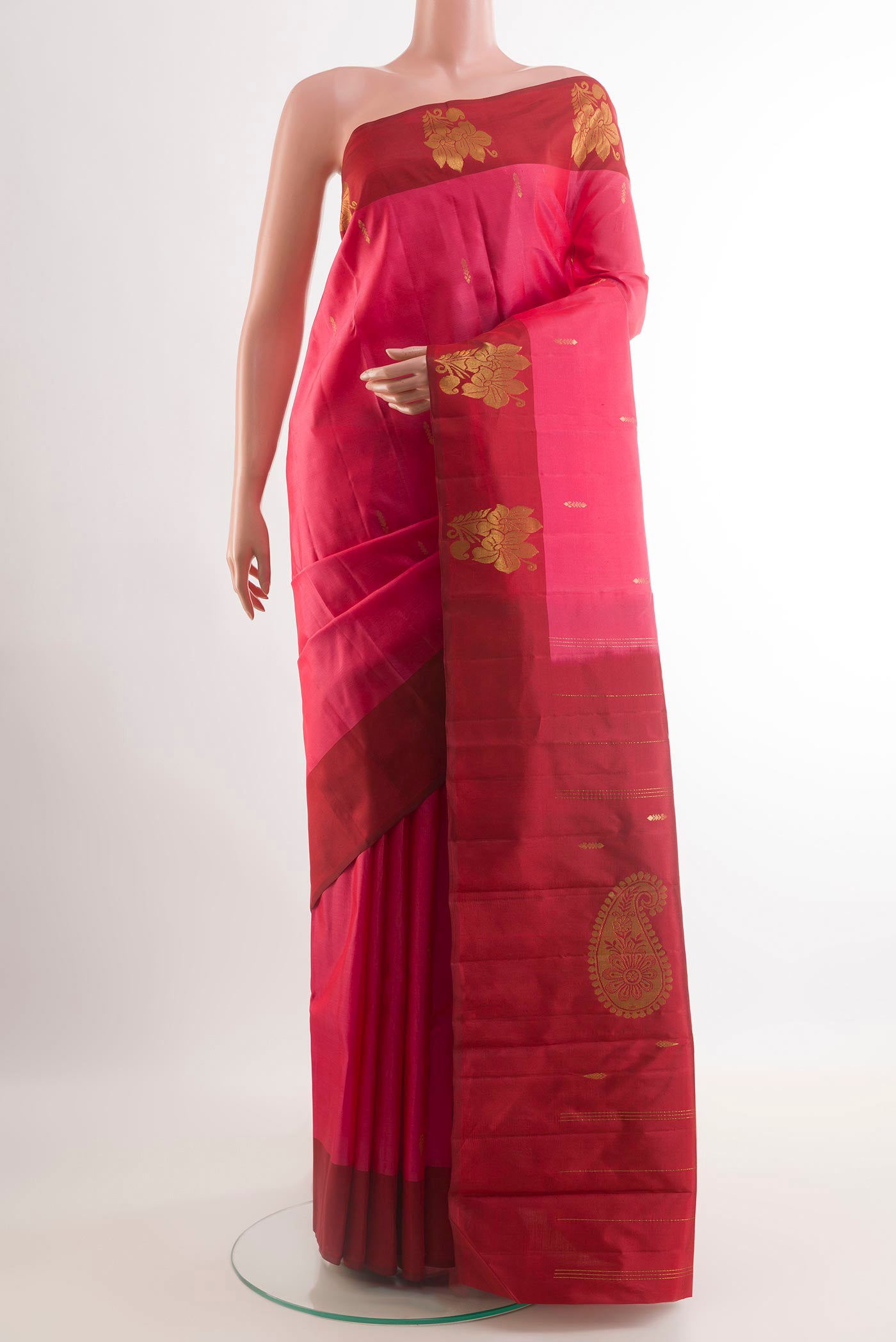 Pink Kanchipuram Silk Saree with Zari Butta on the body and Zari Border.  displayed on a mannequin