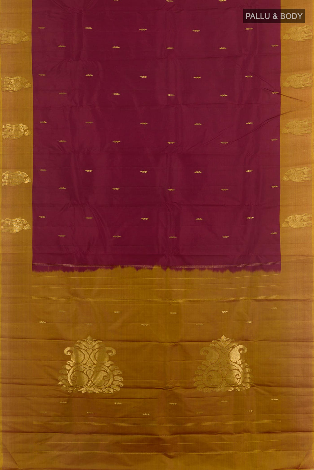 Flat view of Maroon Kanchipuram Silk Saree with Zari Butta on the body and Zari Border. 
