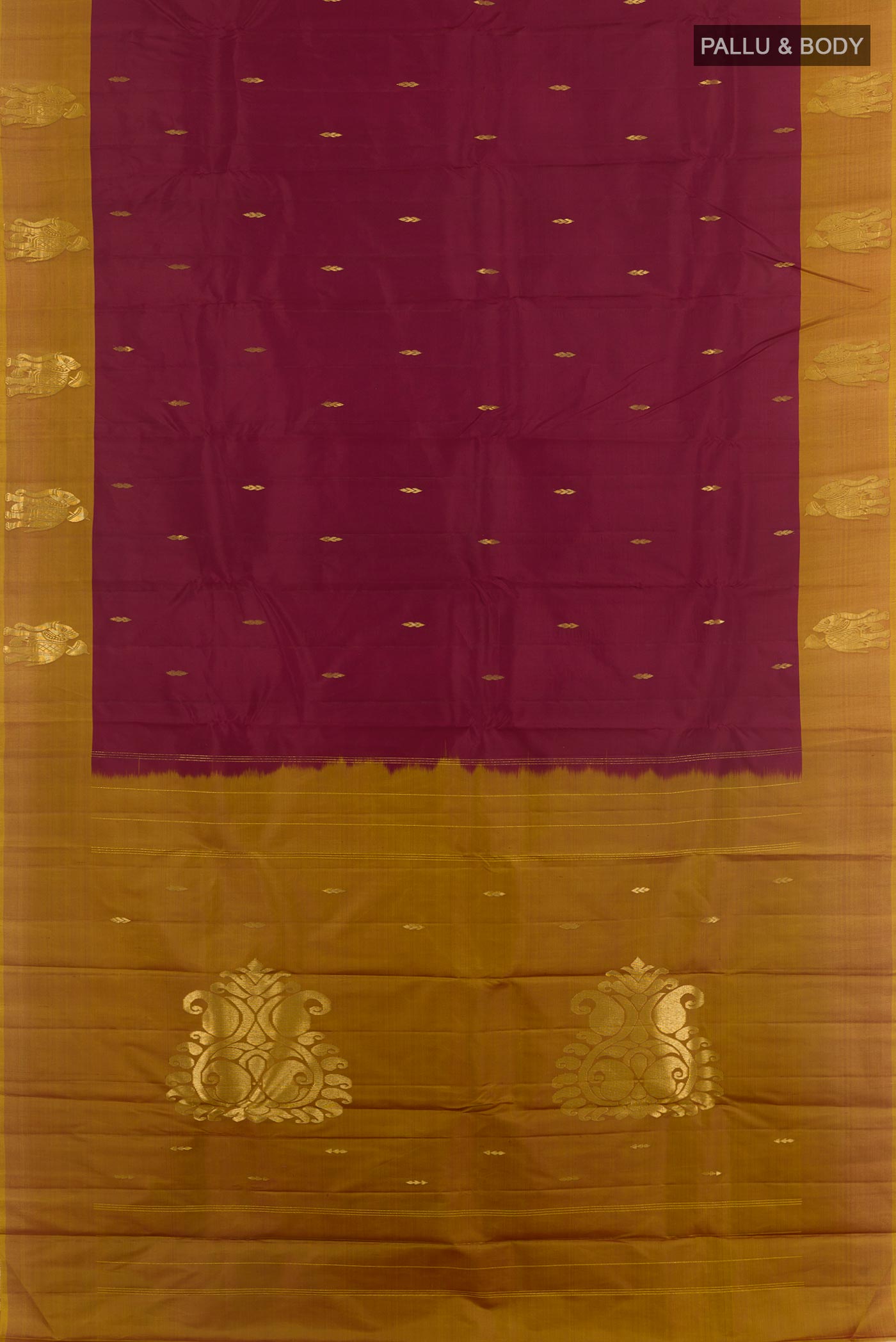Flat view of Maroon Kanchipuram Silk Saree with Zari Butta on the body and Zari Border. 