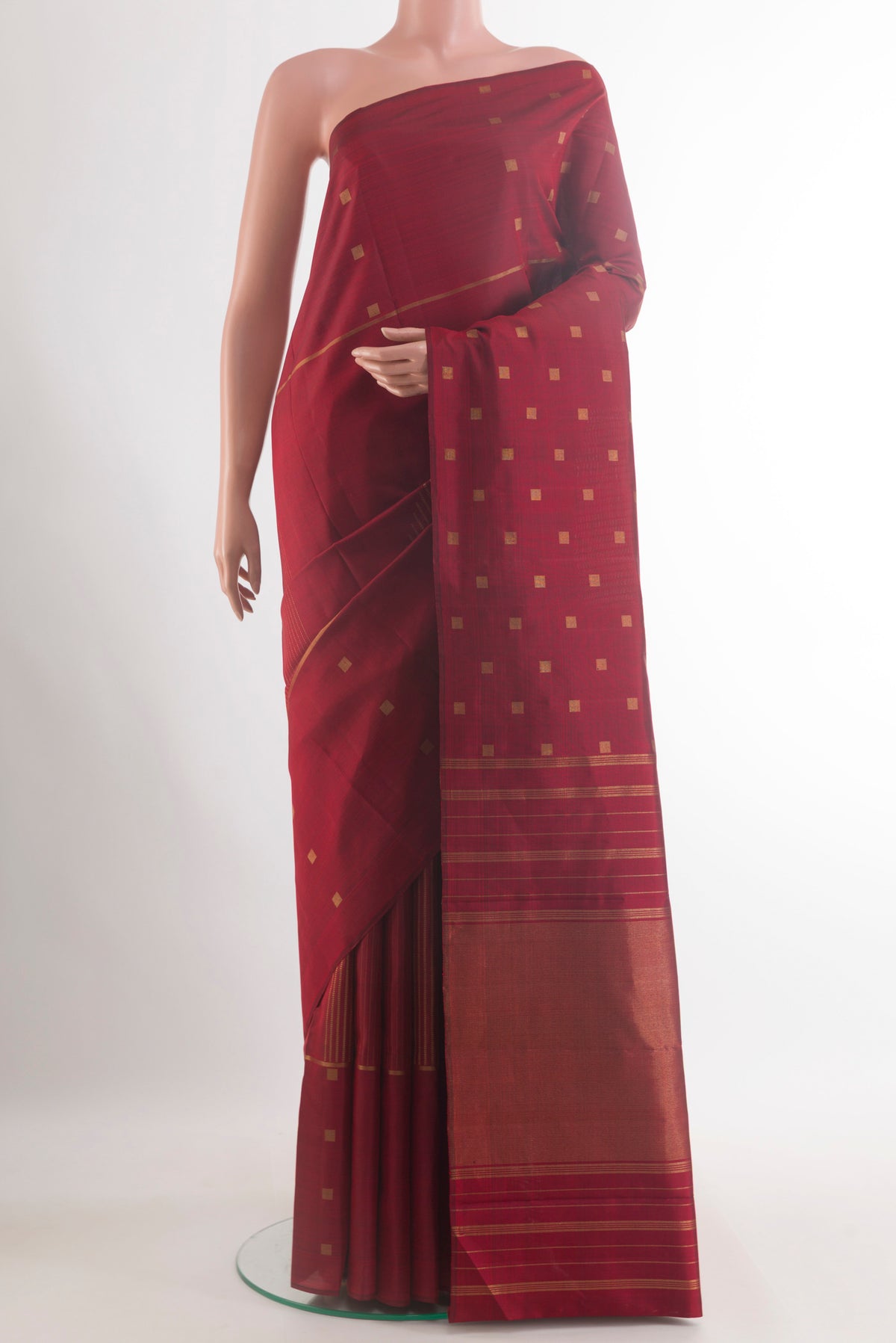 Pure Silk Maroon Kanchipuram Saree with Zari Butta on the body and Zari Border.  displayed on a mannequin