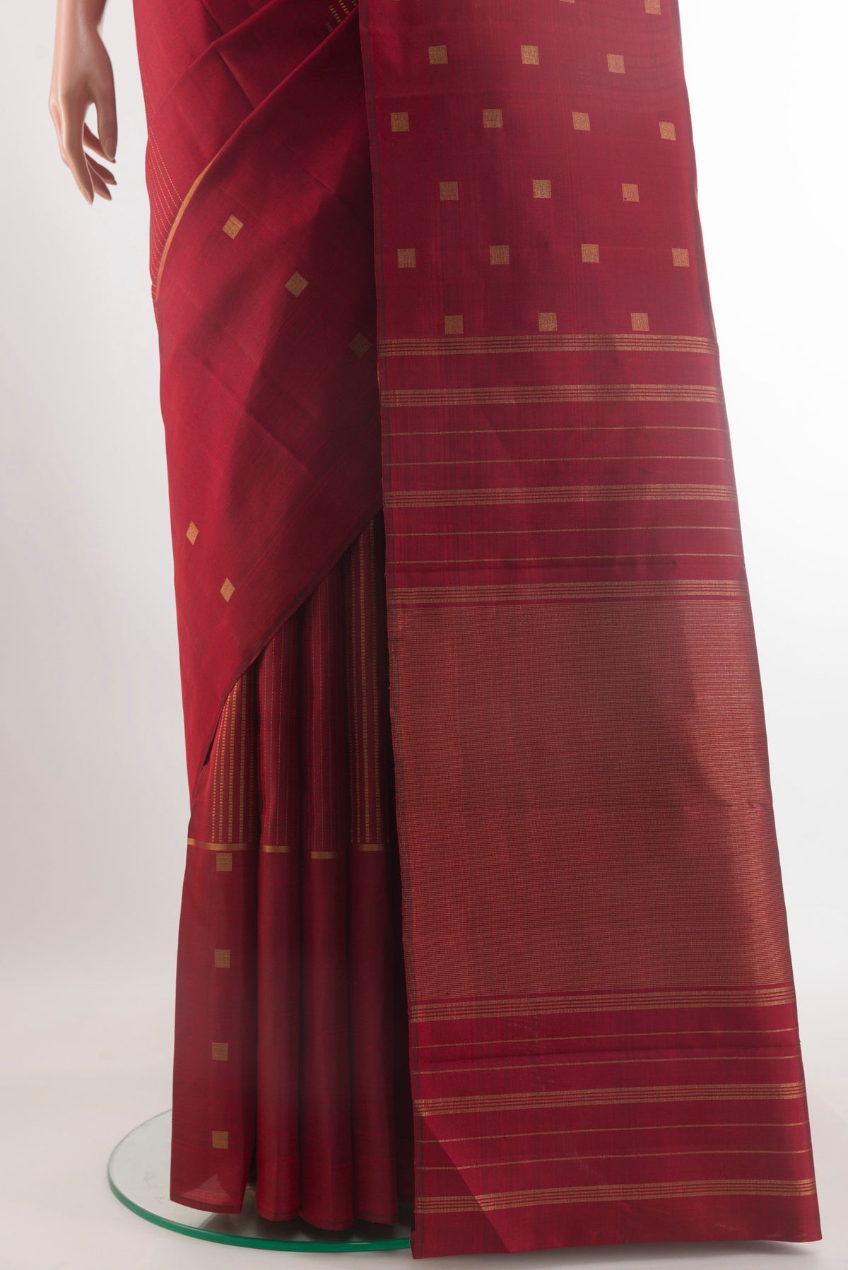 Pleats and pallu of Pure Silk Maroon Kanchipuram Saree with Zari Butta on the body and Zari Border. 