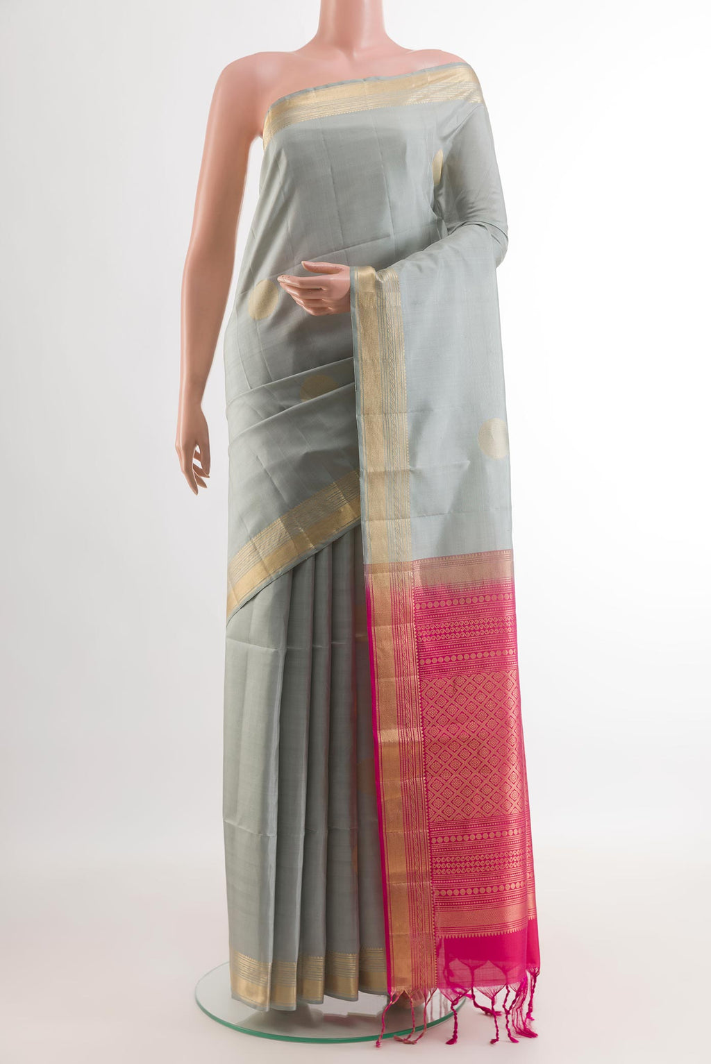 Grey Soft Silk Saree with Zari Butta on the body and Zari Border.  displayed on a mannequin